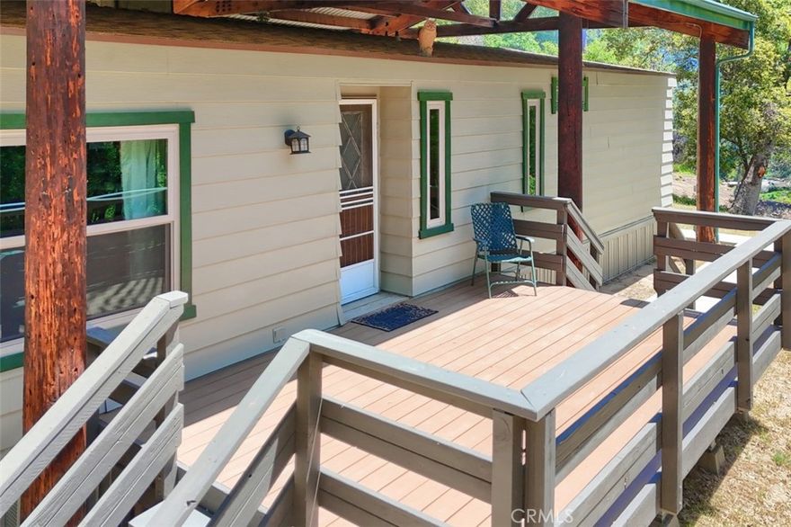 SUMMER SALE! PRICE IMPROVEMENT-Retreat to a simpler life in the tranquil woodlands, this meticulously maintained 2-bedroom, 2-bath + office retreat offers the perfect setting for a slower, more intentional lifestyle. Set on gently sloping land with trails carved throughout, the property invites you to explore, unwind, and reconnect with nature.

The 1,440 sq. ft. home, originally constructed in 1979, is in pristine condition and sheltered beneath a stunning open pole barn that was built to support the 40 pound snow load needed at at 3500 foot elevation—an architectural feature that not only protects the home but adds rustic charm and function. The interior radiates vintage charm while offering thoughtful modern updates, including beautiful newer flooring, windows, exterior paint, deck, evaporative cooler, concrete pad, sidewalks and roof. Step out onto the all-weather deck and take in the peaceful forest surroundings, where birdsong replaces noise and stress.

Whether you're dreaming of growing your own food, setting up solar, or simply savoring quiet mornings on the porch with a cup of coffee, this property offers room to breathe and space to create your own homestead haven. There's ample potential for gardens, animals, or even a completely off-grid lifestyle—all just a short drive from the gates of Yosemite. Contact listing agent for financing options!
