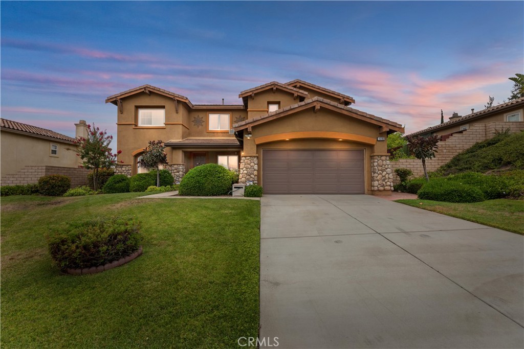 Welcome to Lake Hills Reserve -- where scenic, mountaintop beauty meets everyday comfort. This elegant 4-bedroom with a Loft (OPTIONAL 5th BEDROOM!) Executive Home WITH A BEDROOM/BATHROOM DOWNSTAIRS offers a thoughtfully designed layout perfect for families, multigenerational living, or executive-level buyers looking for flexible space in a truly special setting. As you enter, you're greeted by soaring ceilings and a sun-filled living room framed by plantation shutters. The flow continues into the formal dining room, anchored by a grand chandelier and ideal for both weekday dinners and holiday celebrations. The heart of the home is the open-concept kitchen and family room. Cherry cabinetry, sleek black appliances, and black speckled countertops surround a large central island perfect for casual breakfasts or gathering with friends. The family room, complete with a cozy fireplace, makes it easy to unwind or entertain. Downstairs, you'll find a private bedroom and full bath -- ideal for guests or extended family -- alongside a separate laundry room with washer and dryer included. Upstairs, a versatile loft can serve as a home office, media room, or play space. The primary suite is generously sized and offers his-and-hers walk-in closets, a soaking tub, a glass-enclosed shower, and mountain views to start and end your day with a sense of calm. Additional upstairs bedrooms include one with its own ensuite bath. The backyard is a standout feature—spacious, well-landscaped, and bursting with mature fruit trees (Apricot, cherry, Chinese apple, fig, grape, guava, mulberry, passionfruit, and pomegranate). There's plenty of room for a pool, entertaining area, or simply enjoying quiet evenings with the mountains as your backdrop. Located right across the way from Lake Hills Reserve pool, community center, and Lake Hills Elementary, this home combines space, setting, and convenience in one of Riverside’s most sought-after neighborhoods. Situated on 750 acres, Lake Hills Reserve offers its residents an ideal mountaintop locale removed from city life, yet close to the many cultural and educational amenities of Riverside County and shopping. Residents enjoy the expansive open space, the HIGHLY rated Lake Hills Elementary and a private residents club including a swimming pool, playground, park and an open-air fireplace pavilion. This is an ideal location for commuters as the 91 Freeway and Metrolink are both close by. Are you ready for the Lake Hills Reserve lifestyle?