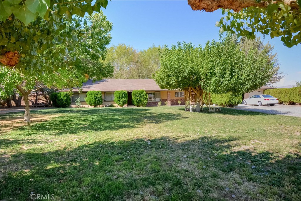 This is a gorgeous home, 4 bedrooms, 3 bathrooms, on over 18 acres of land. Income is produced from approximately 1500 jujube Trees, about 70 plum trees, grapes, apples, pears, and other fruit trees. This property is just off a paved road. This beautiful home has a huge living room with a wood-burning stove. A large workshop and a few greenhouses sit in the back. The property has a well.
