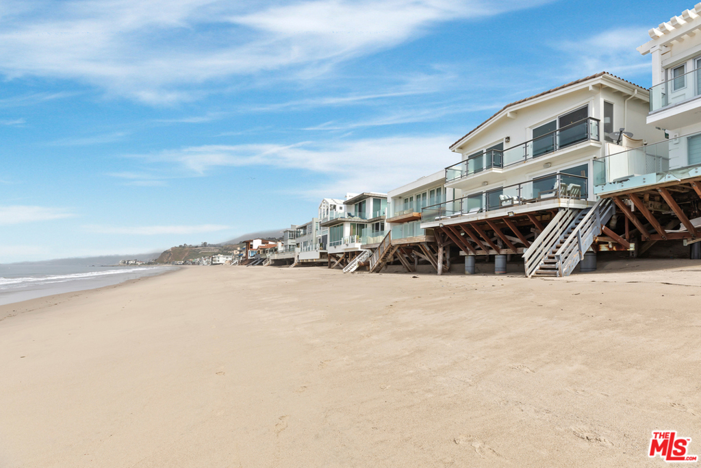 Beautifully designed home on sandy La Costa Beach. A private and gated courtyard leads into a large, open living room, beachfront dining area, and cook's kitchen. The generous outdoor deck is perfect for entertaining, with direct beach access and sought-after views of the coastline, Santa Monica, Queens Necklace, Malibu Pier, and Point Dume. The 2nd floor features a stunning, oceanfront master suite with a sitting area, a generously sized bathroom, high vaulted ceilings, and private deck. An additional 2 en-suite guest bedrooms complete the 2nd floor. A garage plus 2 car off-street guest parking is a huge plus. Conveniently located close to Malibu's best shopping, restaurants, and West LA.
