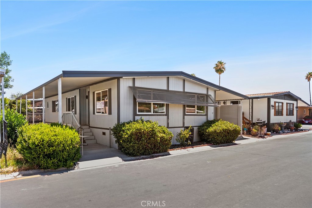 This Turn Key Home is a true gem! Spacious, elegant, and ready for you to move right in —this double-wide manufactured home with a detached garage is a rare find, ideal for entertaining and hosting! The new laminate flooring throughout the home sets the stage for a clean and modern feel. The floor plan is brilliant: a generous primary bedroom with its en suite bathroom. The open concept kitchen flows into the dining area, and the living room makes this home an entertainer’s paradise. Imagine hosting a party with people—whether it’s on the spacious porch, in the living room, out in the yard, there’s plenty of room for everyone! You'll have access to two sparkling pools, a spa, clubhouse, gym, and a wide range of social activities. It’s not just a home—it’s a lifestyle! Plus, you're just minutes away from shopping, restaurants, and medical offices. Schedule your showing today and see what makes this place so special!