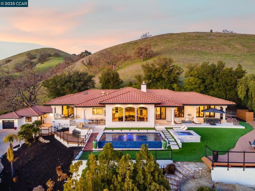 Prestigious, one-of-a-kind estate that offers rare and breathtaking panoramic views. This upscale home combines privacy with resort-style living, situated on 1.33 acres within the exclusive community of Diablo Country Club. Featuring a custom-designed gourmet kitchen, a spacious living room with soaring ceilings, and expansive picture windows overlooking the stunning infinity pool. The oversized ensuite bedrooms include a luxurious primary suite with a walk-through closet and French doors leading to the private backyard. This exceptional home offers a custom theatre room, an at-home gym, and an outdoor built-in BBQ with multiple covered patios, providing spaces for relaxation and entertaining. A high-end guest house provides comfort for family or visitors. Enjoy the best of Diablo living with access to golf, social events, and all the amenities of the highly sought-after Diablo Country Club. Benefit from the acclaimed San Ramon Valley school district, plus easy access to nearby trails and hiking.