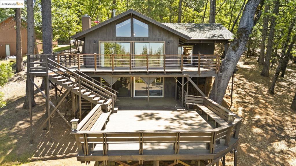 Now offered at a newly reduced price, this is your chance to own a one-of-a-kind mountain retreat at an unbeatable value! Whether you’re looking for a full-time home or a weekend getaway, this property offers the perfect mountain escape. Don’t miss out—opportunities like this in the heart of the Sierra Nevadas and California Gold Country don’t come around often! Discover peace and comfort in this stunning mountain cabin, just one block from the PG&E aqueduct trail offering miles of hiking and fishing. With open-beam cathedral ceilings and natural blue pine interior siding, this home blends rustic charm with modern convenience. Enjoy breathtaking mountain and pine tree views from every window. The spacious living area features a floor-to-ceiling stone gas fireplace, creating a cozy retreat year-round. Two stained glass windows add character and color throughout. The kitchen is equipped with tile counters, tile flooring, and stainless steel appliances—perfect for cooking and entertaining. A private master suite downstairs offers quiet comfort and privacy. Step outside to over 1,500 square feet of decking—ideal for relaxing, stargazing, or hosting surrounded by forest views.