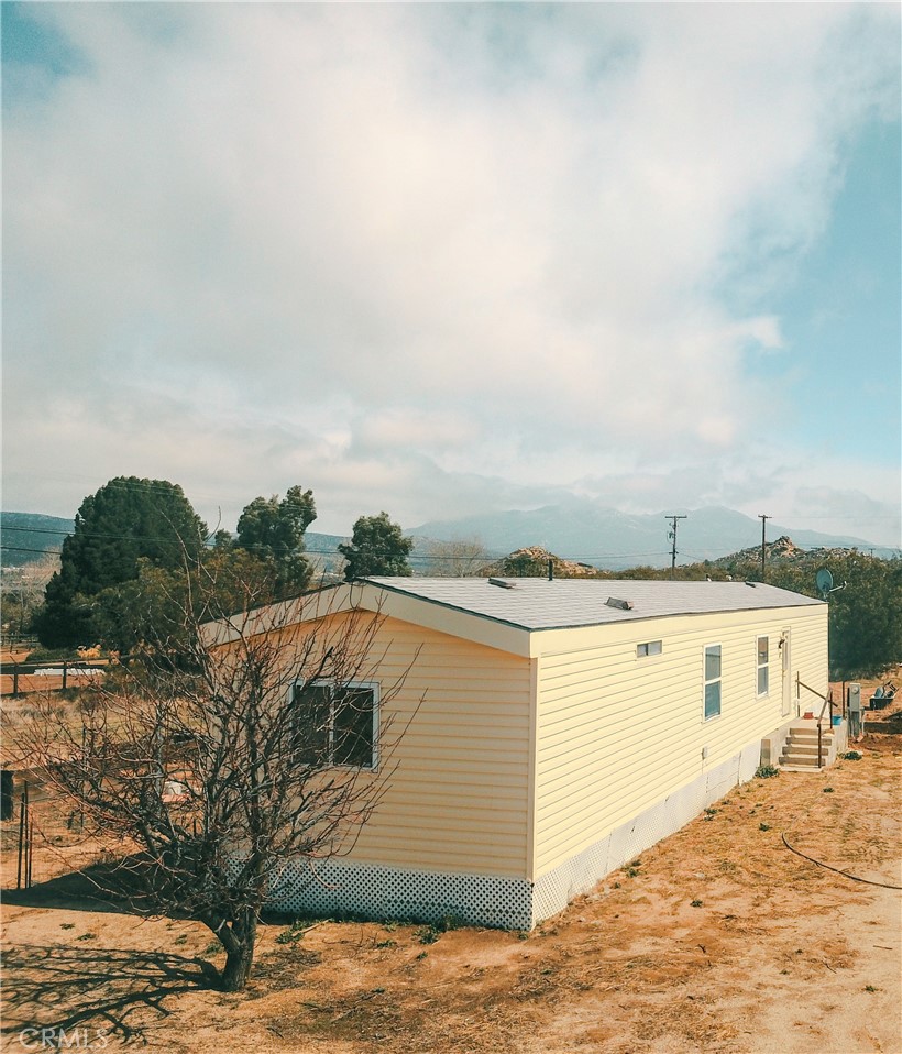Back on the market due to no fault of the Sellers!!!! This home is now on a permanent foundation allowing for conventional financing like FHA and VA!
This charming 896 sq. ft. manufactured home features two bedrooms and two bath, located on a peaceful 2.39-acre property with stunning mountain views. Situated off a paved road, this home is easily accessible, and the property offers ample space with two additional sheds. Enjoy the beauty of surrounding mountains, mild temperatures, starry nights, and fresh air – no smog in sight!
This is the perfect setting to bring your animals, plant gardens, and take advantage of your own well, septic system, and propane services provided by local companies. This mobile home presents multiple possibilities: use it as a rental, or remove it and install a larger manufactured home on a permanent foundation, or even build two homes. The land provides plenty of flexibility for your vision.
Embrace country living with easy access to hiking, biking, and off-roading trails, all surrounded by vibrant wildlife. Experience the beauty of California’s four seasons, including occasional winter snowfall. Convenient stores are nearby, and the small-town atmosphere offers the perfect place to relax and recharge. Plus, you’re just a short drive from Temecula Wine Country, ideal for those who enjoy a glass of wine at the local wineries.
Don’t miss out on this unique opportunity to own a piece of rural paradise! Owner willing to provide seller carry back financing with 75% cash offer.