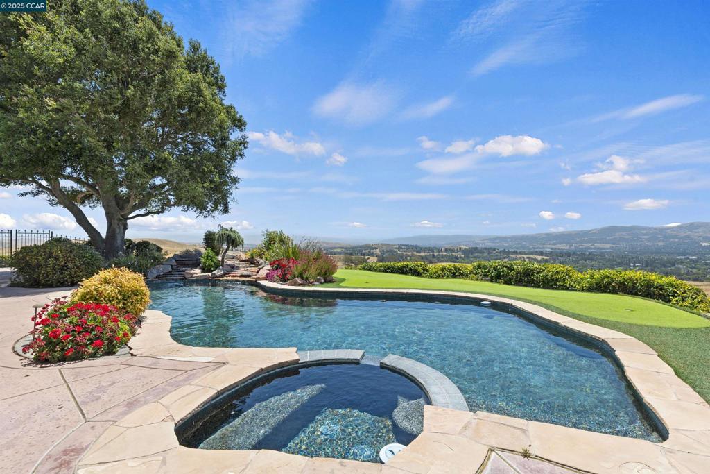 Unique one-of-a-kind setting! Perched atop one of Danville’s most picturesque ridgelines; this ranch style, single-story estate offers the ultimate in privacy, luxury, and jaw-dropping panoramic views of the entire Tri-Valley. Opportunities are endless for an expansion estate. Set on 5.6 serene acres, this 4 bedroom, 3 bathroom home spans over 3,100 sq ft and picturesque views from every room throughout. From the moment you arrive, you’re greeted by a private driveway, lush landscaping, and a sense of quiet tranquility that makes you feel miles away yet you’re just minutes from top-rated schools, downtown Danville, freeway access, and world-class shopping. Step inside to a light-filled, freshly painted interior with gorgeous hardwood floors, recessed lighting, and crown molding throughout. Every room features spectacular views, creating a seamless connection between indoor comfort and outdoor beauty. The open concept floor plan is perfect for entertaining, with generous living areas and thoughtfully designed spaces that flow effortlessly from one to the next. While the three-car garage and pool add extra convenience and flexibility. Step outside to your private oasis, where a sparkling pool, expansive patio, and unmatched views, sunrises and sunsets! Views: Ridge