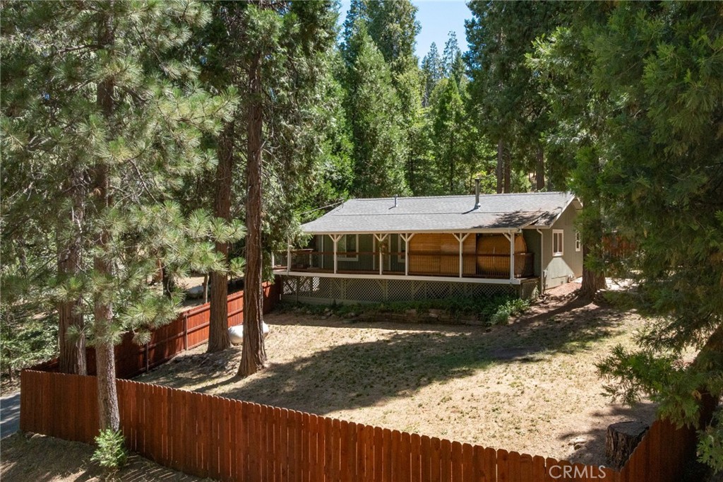 Tucked away in the peaceful, pine-studded neighborhood of Jerseydale, this 3-bedroom, 2-bathroom mountain home offers comfort, charm, and functionality on a generous 0.8-acre lot. With 1,460 sq ft of living space, plus a bonus room, this property is thoughtfully updated and move-in ready.
The beautifully updated kitchen features granite countertops and flows into a cozy living room complete with a fireplace that is perfect for chilly mountain evenings. The home has been upgraded for efficiency with three mini-split units for heating and cooling, return vents, a tankless hot water heater, and newer dual-pane windows throughout. A brand-new Briggs & Stratton generator is also ready to be wired in, providing backup power when needed.
Enjoy outdoor living from the large front deck, which includes a 4-person sauna, or relax in the fully fenced front yard with a beautiful cedar fence. The backyard is also fenced with a combination of cedar and metal for privacy and durability. Additional highlights include a paved driveway, two-car carport, a Tuff Shed for extra storage, and a functional bonus room for added flexibility.
This home offers the perfect mountain lifestyle with it being located in scenic Jerseydale that is known for its towering pines, cooler summer temperatures, and occasional winter snow. The seller is open to including all appliances and large furniture, offering the opportunity for the home to be sold fully furnished and truly turnkey.