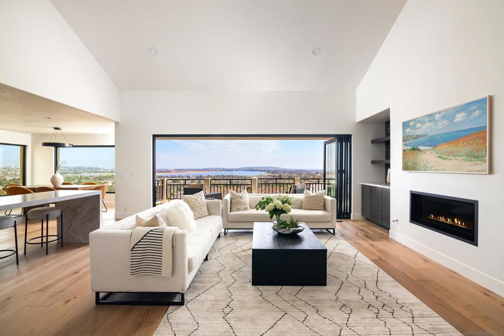 With the best view on the market, 2481 La Marque is Pacific Beach at its finest. Perched atop one of the area's most desirable hillside enclaves, this reimagined coastal retreat delivers unobstructed, panoramic and direct vistas centered on Mission Bay, Downtown, Coronado, and the Pacific Ocean. From sunrise to sunset, no other current listing can match the visual experience this home offers. Listed $200,000 below appraised value, the home blends timeless design with smart functionality. The main level features a dramatic great room with vaulted ceilings, a chef’s kitchen with custom quartzite counters, a six-burner stove, double oven, and a windowed butler’s pantry. The elegant primary suite and an additional bedroom enable easy single-level living. Expansive decks and bifold doors blur the line between indoors and out, while a dining room picture window captures the sunrise. Downstairs, two more bedrooms, a full kitchen, bath, and a separate private entrance from the street below offers flexibility for guests, multigenerational living, or rental income. Every room showcases the view, reinforcing both the luxury and long-term value. The patio is gas-ready for a grill or hot tub. Upgrades include all-new landscaping, modern dual-pane windows, and new doors. This home is in absolutely mint condition, ready for move-in asap. Quietly tucked above the city yet minutes from the beach, restaurants, and freeway access—2481 La Marque offers a rare front-row seat to San Diego's iconic sights.