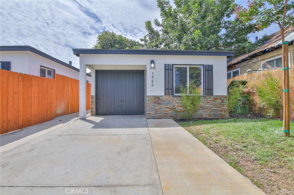 Great Starter Home. Move in ready... Features include: 2 Bedrooms / 2 Bathrooms + Partially Converted Garage with a Kitchenette, Beautiful kitchen with granite counter tops, updated bathrooms, Tile flooring in Living room, Kitchen, and Baths, New Carpet in Bedrooms. Uncovered driveway parking. Alarm on property, Freshly painted interior and exterior. This is a must see!