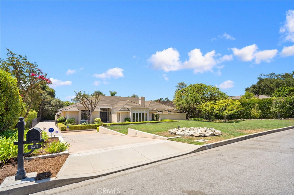 Situated in Arcadia's prestigious Upper Rancho neighborhood, this spectacular estate-property is located on one of Arcadia's most coveted streets, Singing Wood Drive. The sprawling 6,336 sq ft floorplan is primarily on a single level w/ 6 bedrooms (all suites) + an office and 8 total bathrooms. Upon arrival, you will be greeted by lushly landscaped grounds and mountain views. As you enter into this remodeled home with upgrades galore, there is a formal living room with high ceilings, recessed lights, wood floors, a cozy fireplace, and picture windows. Across the hallway is the large formal dining room, which leads to the gourmet kitchen w/ breakfast nook. The open-concept kitchen, which opens to the family room, features a large center island, built-in gas range, oven, microwave, 2 dishwashers and refrigerator, along with abundant cabinetry. This home is truly an entertainer's dream with both the family room and adjacent entertainment room opening to the backyard & patio. The entertainment room has a wet bar, along with a powder room. The main-level of the home also features a spacious office w/ built-in cabinetry. Down the main hallway are 3 bedrooms, including the spacious primary suite w/ retreat area. The primary suite has 2 walk-in closets, including one with extensive built-in cabinetry, a large retreat/sitting area w/ a cozy fireplace, French doors leading to a private patio area, and a large ensuite bathroom with dual sinks, and separate tub & shower. Off of the kitchen, there is a laundry/utility room w/ laundry hookups and guest quarters with a separate entrance off of the driveway. The guest suite has an additional laundry room, which could also be converted to a 2nd kitchen. A few steps above the entertainment room and above the garage are 2 additional expansive suites, which share a large balcony/deck overlooking the pool & backyard. The backyard has a large covered patio/dining area, along with landscaped grounds, a sparkling pool with 2 changing rooms, and a huge enclosed dog run. Down the long driveway is a finished 3-car garage with additional storage. The basement provides much more storage and features a large climate-controlled wine cellar. Additional features of this spectacular home include 4-zone HVAC, 3 water heaters, wired for sound & alarm/camera systems, automatic sprinklers, copper plumbing, updated electrical, and much more. All of this, along with Arcadia's award winning schools. Do not miss this opportunity!