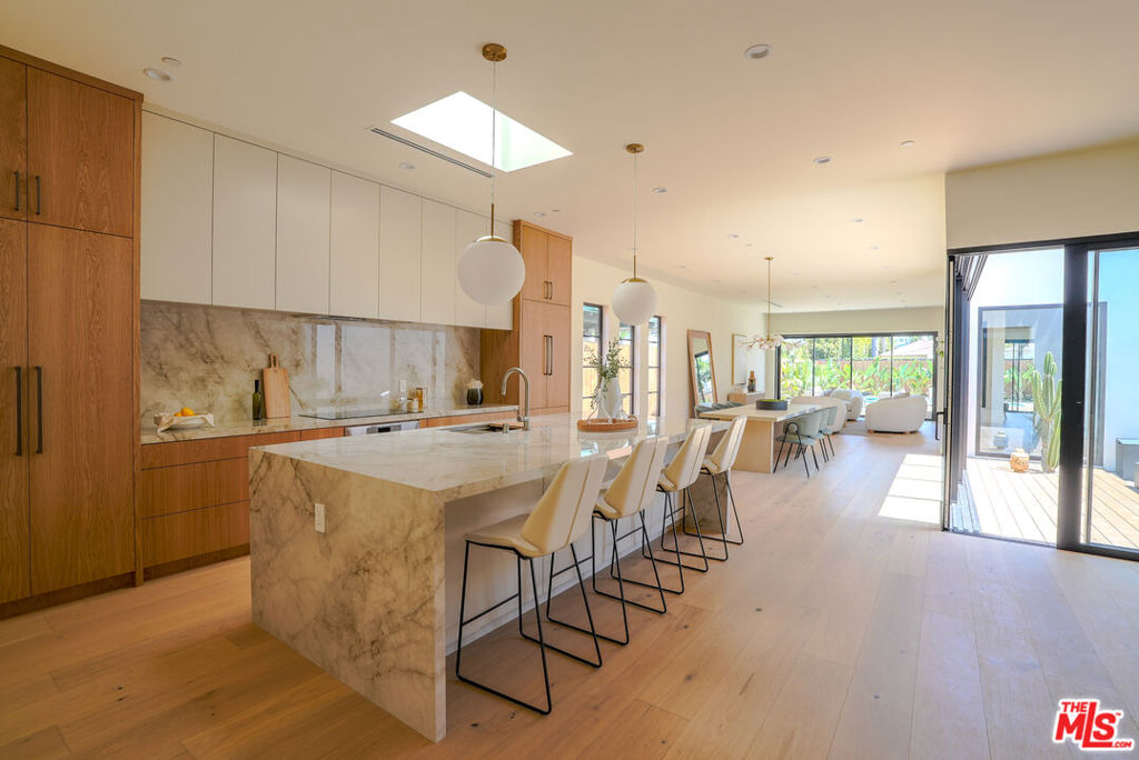 A one of a kind new construction one story single-family residence in Culver City/Del Rey neighborhood sitting on a large lot, this expansive home offers a meticulously designed open living space with a great layout featuring 10ft ceiling with plenty of natural light and boasting 4 spacious bedrooms and 4 luxurious bathrooms. Upon entering the house through a custom steel door, you are greeted with 9 1/2'' wide white oak engineered wood floors and a skylight filling the entry hallway with every daylight you can get. No expense has been spared with custom white oak cabinets in the kitchen and bathrooms, Thermador built-in appliances, travertine stone finishes and European tiles along Watermark and Phylrich fixtures throughout. The thoughtfully designed layout seamlessly connects the interior to a private courtyard and an extraordinary backyard oasis. Experience the ultimate in relaxation and entertainment with an in-ground heated pool and jacuzzi, perfect for unwinding or hosting guests. The outdoor space is a true entertainer's dream, featuring a built-in barbecue area, a cozy fire pit and an outdoor shower. Enjoy the serenity of the courtyard or soak up the sun on the spacious decks, offering ample opportunities for outdoor enjoyment. Centrally located at the end of a quiet cul-de-sac by Culver Park, the property is only a short drive from all restaurants, shopping and entertainment in Downtown Culver City, Playa vista and Mar Vista. 4936 Coolidge Ave offers functionality, warmth, elegance, and an elevated design, a MUST SEE!