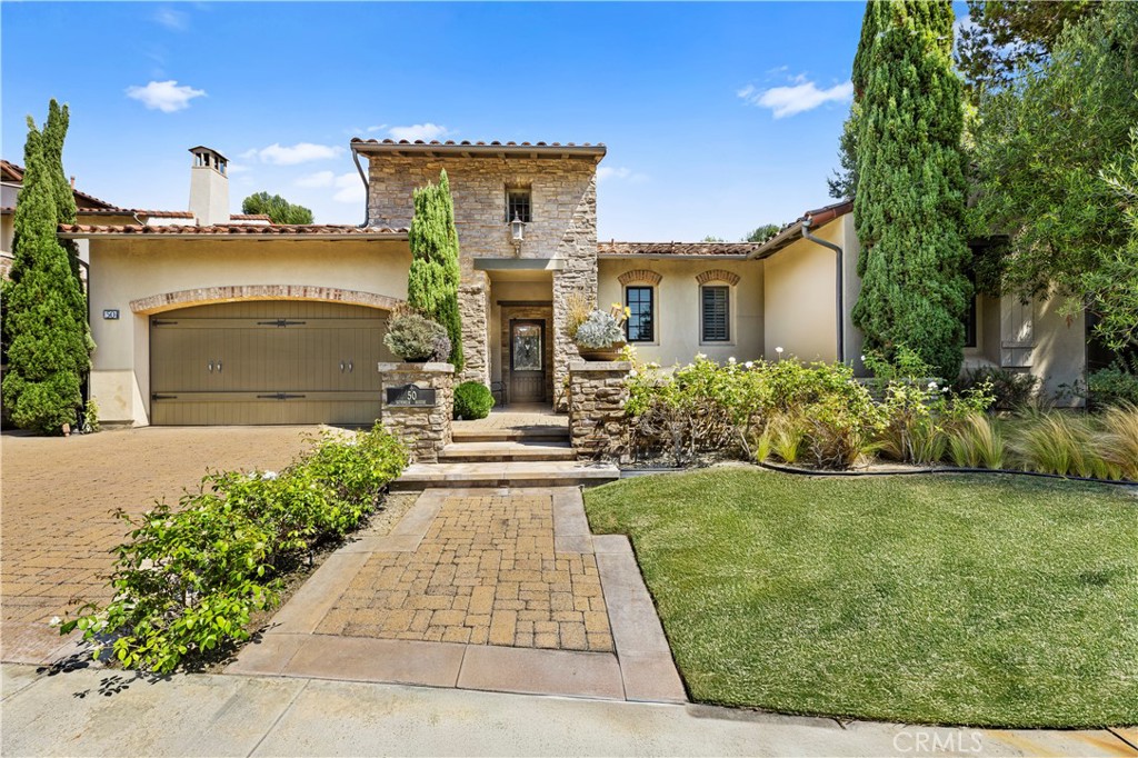 Rarely available, single-level living awaits at 50 Summer House in the prestigious guard-gated community of The Summit at Turtle Ridge. Set on nearly 12,000 square feet of private grounds, this residence offers over 3,100 square feet of interior space with 4 bedrooms and 4.5 bathrooms. Elegant details include beautiful wood floors, soaring ceilings, and abundant natural light. French doors throughout connect seamlessly to the outdoors, creating a true indoor-outdoor lifestyle. The spacious great room with fireplace and formal dining area anchors the home, while the kitchen impresses with a sun-filled breakfast nook, large center island with seating, professional-grade appliances, dual ovens, and a Sub-Zero refrigerator, opening directly to the family room. The primary suite is a private retreat with its own fireplace, spa access, and a spa-like bathroom featuring a soaking tub, walk-in shower, dual vanities, and a large walk-in closet. Secondary bedrooms are generously sized with built-ins, shutters, and French doors to a central courtyard. Additional highlights include a separate laundry room with sink and storage, three-car garage with ceiling storage and water softener, and multiple fireplaces. The backyard is designed for entertaining with custom pavers, a built-in BBQ, ample space for dining, a turf area currently used for golf practice, a sizable side yard, and an oversized spa. Surrounded by green hillside views, the property offers unmatched privacy. Residents of The Summit enjoy access to walking trails, two pools, a clubhouse, fitness center, and theater room, all within a 24/7 guard-gated enclave. Conveniently located near Newport Coast, top-rated schools including University High, and major freeways and toll roads, this single-level estate represents a rare opportunity in one of Irvine’s most sought-after communities.