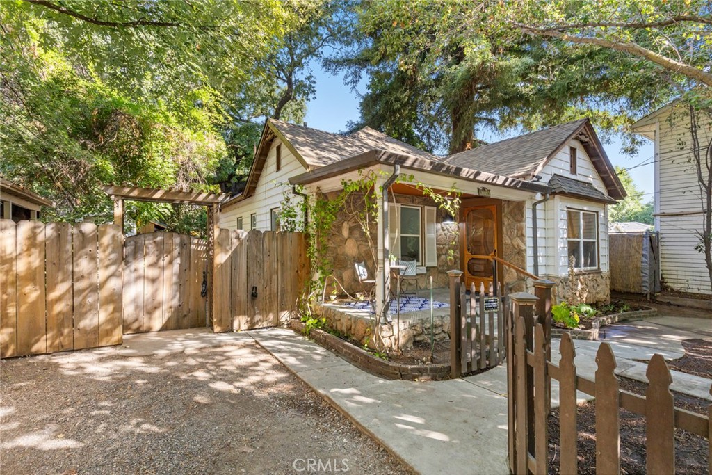 Located just blocks from both downtown Chico and Bidwell Park, this charming home blends vintage character with thoughtful updates. Spend your mornings strolling to favorite local coffee shops or exploring the park’s scenic trails, then come home to tall 9-foot ceilings, original hardwood floors, and classic touches like vintage door handles, moldings, and baseboards. Modern comforts include dual-pane windows, central heat and air, a gas stove, and ceiling fans. The kitchen features a gas range and a cozy breakfast nook with views of the inviting fenced backyard. Enjoy the convenience of indoor laundry with a stackable washer and dryer included. Out back, a fieldstone patio shaded by beautiful mature trees sets the stage for relaxing or entertaining, complete with an outdoor kitchen, storage/workshop shed, and alley access.
