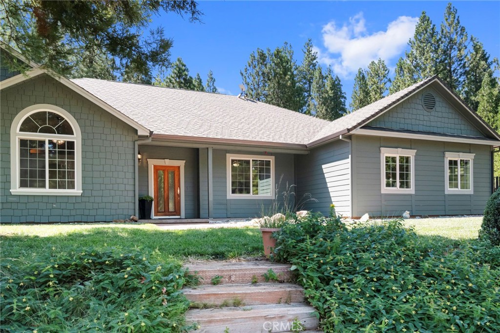 Welcome to 4731 Christina Drive, a Forest Ranch retreat that offers the best of both worlds: community and privacy. Nestled on 5.02 acres, this 3-bedroom, 2.5-bathroom home spans 2,807 sq. ft. and was thoughtfully designed to balance comfort, function, and connection with the outdoors. Whether you’re working from home, hosting family gatherings, or simply seeking a peaceful escape from city life, this home has it all. Step into the foyer and you’ll find a cozy family room, perfect for welcoming guests, and a private office across the way, an ideal setup for remote work or creative pursuits. Beyond the entry, the heart of the home opens into a spacious living room, dining area, and kitchen designed for entertaining. Soaring ceilings and a floor-to-ceiling stone fireplace make the living space warm and inviting, while the open layout keeps everyone connected. The kitchen is a dream for both everyday living and hosting, offering a pantry, generous counter space, a central island, and bar-top seating that flows into the dining area. The split floor plan provides comfort and privacy for all. On one wing, you’ll find two large bedrooms, one with a walk-in closet and another with direct backyard access, plus a full hall bathroom. On the other side, tucked near the kitchen, is a half bath, spacious laundry, and utility room with storage, and the primary suite. This retreat-like space features backyard access, two walk-in closets, and a luxurious en-suite with dual sinks, a walk-in shower, and a soaking tub perfect for unwinding at the end of the day. The backyard is where this property shines. Step onto the oversized covered patio, spanning the length of the home, and take in the peaceful setting. Surrounded by mature trees, the fenced area is perfect for entertaining, pets, or play, while still offering access to explore your acreage beyond. Whether it’s summer BBQs, crisp fall evenings by a fire pit, or spring mornings with coffee and birdsong, this outdoor space is designed to be enjoyed year-round. For those who need space for hobbies, vehicles, or projects, you’ll love the attached two-car garage plus a detached garage with workshop. Upstairs, a large attic space provides storage or the potential to finish into whatever your lifestyle calls for. Living in Forest Ranch means being part of a welcoming community while still enjoying the privacy and tranquility of acreage. 4731 Christina Drive isn’t just a home, it’s a lifestyle.