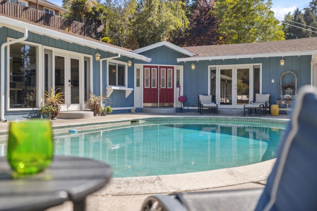 Welcome to your own private oasis in the heart of the sought-after Whispering Pines neighborhood. Located on a quiet cul-de-sac, this turnkey 4 bed/3 bath home, complete with a beautifully finished detached ADU offers the ideal setup for multi-generational living, extended guests, or additional rental income. The main residence is designed for connection and comfort, featuring an open-concept layout filled with natural light, vaulted ceilings, floor-to-ceiling windows, and a cozy gas fireplace. French doors throughout the home create a seamless indoor-outdoor flow to a sunny patio and resort-style pool, perfect for entertaining or relaxing with guests. The spacious primary suite opens directly to the pool deck, offering a private space for peaceful mornings or starlit evenings. The detached ADU provides a fully private and thoughtfully designed living space, ideal for multi-generational living or even as a rental. Complete with its own entrance, the ADU is a versatile gem that truly expands the way you live. Surrounded by trees yet close to everything, enjoy easy access to local shops, hiking trails, farmers' markets, and cozy cafes, plus a quick drive to Santa Cruz beaches or the Bay Area.