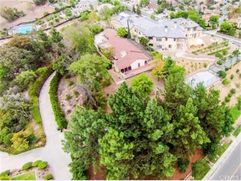 Selling for land value only. This prime, usable 1.83-acre lot is perched high in the prestigious, 24-hour guard-gated community of “The Country Estates,” surrounded by multi-million dollar luxury homes and offering breathtaking panoramic valley views.
The property is currently configured with a Main House on the upper level and a Guest House with a Pool below. Both the existing home and guest house are uninhabitable, and the seller will not be making any repairs. A custom mansion plan, designed by a renowned architect, was approved by the city in September 2019 (now expired) for an opulent 15,000± sq. ft. estate. The design features 9 suites, guest quarters, a sprawling 1,500± sq. ft. great room, a gym, a courtyard, pool, a tennis court and a basement garage accommodating 7+ cars.
Buyers are responsible for verifying and satisfying all requirements with the City of Diamond Bar and the HOA regarding plan renewal or modifications.
Located in the award-winning Walnut Unified School District.
Don't miss this rare opportunity to build your dream estate!