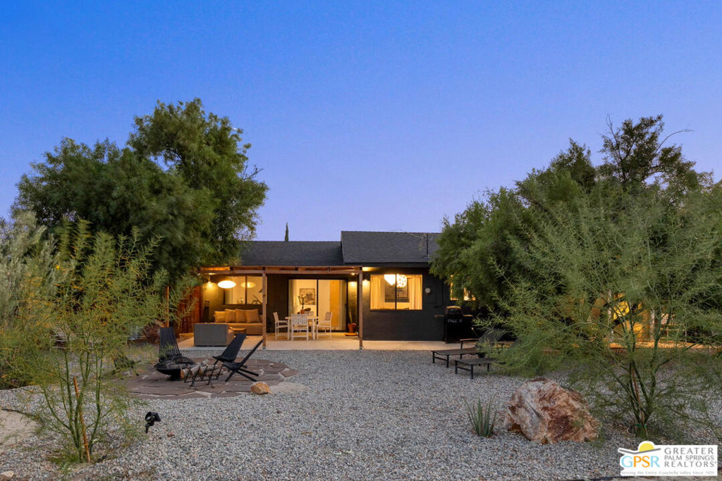 Welcome to Casa Cookie, a Dwell-featured desert getaway, on a lush 0.4-acre corner lot in Morongo Valley. This modern ranch-style home is ready to become your turnkey oasis, sparing you the time, effort, and challenges of renovating in the desert. Enjoy vaulted ceilings and an airy open floor plan with a kitchen that features custom maple cabinets, new appliances, designer lighting, and a cozy dining nook. The garage was converted into a light-filled creative workspace, adding an extra 374 sqft of livable space, a bathroom and an expansive picture window framing the stunning mountains of the Sand to Snow Monument. Designed with privacy in mind, the fully fenced front and back yards are meticulously landscaped and offer more than enough space for a future inground pool, ADU, or spot to park your airstream. Only 20 minutes to Joshua Tree, Palm Springs, and Pioneertown, and 2 hours from Los Angeles! All information deemed accurate, buyer to verify. The furnishings were lovingly selected for this space and, if desired, can be purchased outside escrow.