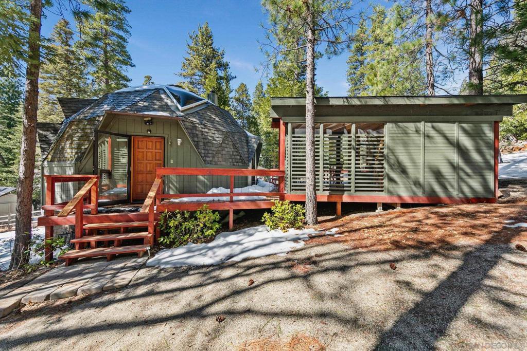 Secluded 1.80 acre Mountain Retreat in Pine Wood Discover a truly unique off-grid sanctuary nestled on 1.80 private acres in Pine Wood, just outside Idyllwild. This one-of-a-kind property features five separate structures, offering flexibility, privacy, and endless possibilities. The centerpiece is a spacious dome home with a spiral staircase leading to a loft for sleeping or storage, abundant skylights, a wood-burning stove, and a wall-mounted heater for year-round comfort. A small but functional kitchen and full bathroom complete the space. Additional structures include a separate guest house with a half bath and screened-in porch, a personal sauna, and a dedicated office with a screened-in deck, seamlessly connected to the home’s wraparound wood deck. A storage shed with solar panels provides extra functionality. Surrounded by towering trees and abundant wildlife, this peaceful retreat offers well, septic, and propane, ensuring self-sufficient living in a serene, natural setting. Experience the ultimate mountain getaway while being just minutes from Idyllwild’s charming shops, restaurants, and art scene.