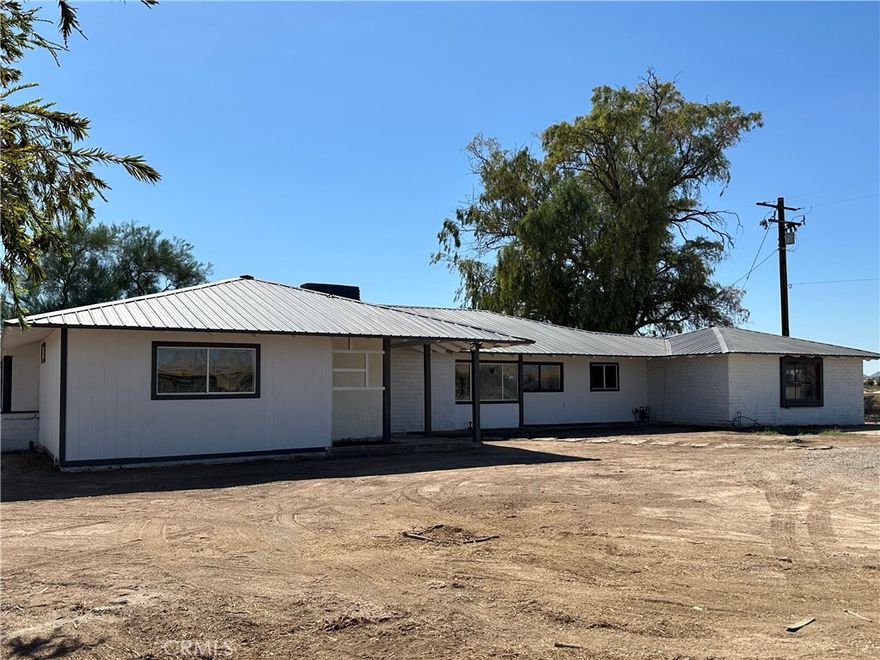 Welcome to this beautifully remodeled 3-bedroom, 3-bathroom ranch-style home at 14563 W 14th Ave! Nestled on a spacious lot with horse corrals in the front yard, this unique property is perfect for those who love country living with modern amenities.

Step inside to discover an inviting open-concept living room with a cozy fireplace, perfect for relaxing evenings. The fully remodeled kitchen with all new kitchen appliances (refrigerator is 29 Cubic Feet), Stove is self cleaning and has two ovens. Bottom one is Conventional Oven (rapid baking) and bathrooms feature modern finishes, offering both style and functionality. 

The home also has all new sewer lines, new A/C, newly serviced well, new metal roof provides durability, and the rear-facing garage adds convenience and privacy. Enjoy peaceful mornings or evenings in the enclosed rear porch, ideal for outdoor entertaining or quiet moments. This home is a perfect blend of rustic charm and contemporary comfort, ready for you to move in! Don't miss out on this rare gem with equestrian potential, modern updates, and plenty of space to enjoy both indoors and out!