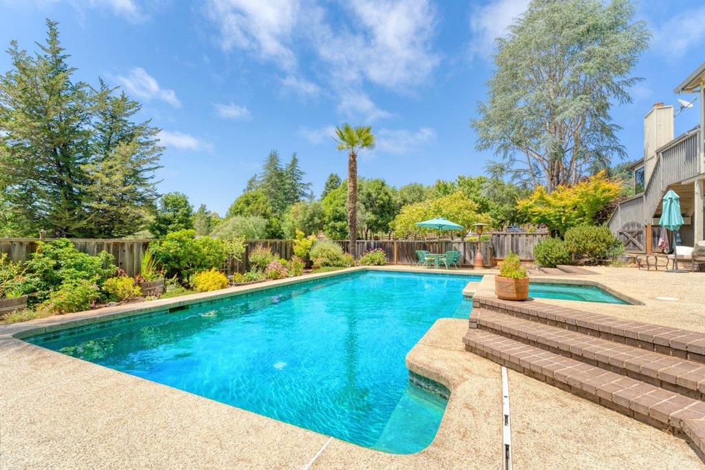 Day Valley capture the Aptos sun here, this special 5BR, 3BA home seamlessly combines space with comfort. Spanning 3,376 square feet on a spacious 1.3-acre lot, this residence invites relaxation and privacy. Open and airy inside with vaulted ceilings and tons of abundant natural light pouring through the many skylights and windows. The primary suite stands out with its high ceilings, a remodeled shower, and a spacious walk-in closet. Three cozy fireplaces enhance the family room and living areas.. The home's thoughtful design includes two upper-level bedrooms and a versatile lower level with three additional bedrooms and a large recreation room. Which has a separate entrance, offering flexibility for guests or creative endeavors, studio, or large office. Unwind by the sparkling pool, relax in the spa, or enjoy the garden beds protected from wildlife. The outdoor space is perfect for pets, gardening, or leisurely retreats. Three-car garage provides ample storage, plus room for RVs or boats. Conveniences include air conditioning, laundry room, and private outdoor areas, all supported by solar with battery system for this all electric home. Horse corral. Pool, workshop, expansive outdoor space, deer fenced garden, large study or office, amazing neighborhood. New Price!