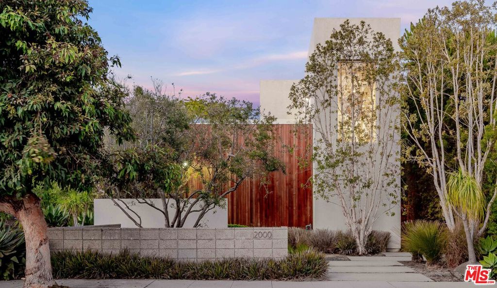 Ocean air wafts gently east from the sandy shores of Venice Beach to this immaculate architectural gem @ 2000 Walnut Ave. Built in 2016, Carson Architect's masterpiece offers wide-plank oak flooring throughout the open floor plan design, seamlessly blending first floor living, dining and kitchen spaces with soaring 10' ceilings, walls of sliding glass doors and a separate bedroom/office/den and 3/4 bath.The open kitchen is lavishly appointed with walnut cabinetry, an array of Bertazzoni, Thermador and Bosch appliances, stainless steel farmhouse sink and breakfast bar to compliment the kitchen island. Completing the lower level is direct access to the 2 car garage and 8' sliding glass doors leading to the exterior wooden deck, al fresco dining, lounging, firepit area, under a canopy of trees shading a private, walled and gated entertaining area.Oak floors lead upstairs to 3 en suite bedrooms featuring a lavish primary suite with 8' windows, floor to ceiling walnut cabinetry in the dressing area, dual vanities, rain shower head and acrylic bathtub in the primary bath. Completing the upstairs is the laundry room and 2nd floor access to the private, open-air entertainment/sun deck to soak up the Southern California sun and endless sunsets. California Dreamin' comes true!