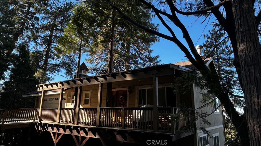 Spectacular Crestline home with Awe Inspiring Views of Lake Gregory and Mt Baldy. Enjoy this newer 3 bedroom 3 baths home with a level entry Garage and covered Front Porch complete with Bench Swing. The main level living, dinning area offers hardwood flooring, a stone fireplace, and open to the spacious Kitchen with granite countertops, dual ovens, and center island with copper vegetable sink. Absolutely Ideal for Entertaining! The bedrooms are downstairs off of the Game Room and second deck. The Master Bedroom with rock fireplace and large ensuite bath is your own sanctuary. All 3 Levels have Decks with Panoramic Views. Take in the Amazing Sunsets, Star Filed Sky's, and even the 4th of July Fireworks over the Lake. The 3rd level is accessed by exterior stairs and ready to be completed as an ADU or utilize the builder designed access to allow for an interior staircase to expand to be a full 3 level home. Additionally, the house is located at the end of the Road offering Extra Privacy! This is the one you've been waiting for!