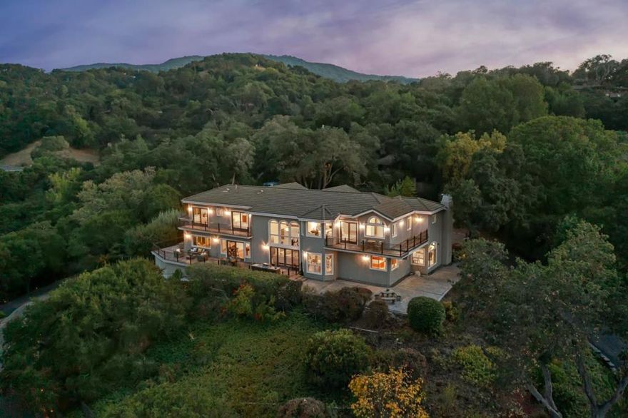 Indulge in breathtaking city lights and mountain panoramas from this exquisite Los Gatos estate, nestled within the confines of a secure gated property spanning 1.67 acres. Beyond the grand entrance, a 4,900+/- square-foot haven awaits, boasting 5 bedrooms and 4.5 baths that seamlessly blend opulence with a welcoming ambiance. Hardwood floors, expansive picture windows, lofty ceilings, and generously proportioned spaces define the tastefully adorned interior, creating an inviting atmosphere for both relaxation and entertainment.  The residence effortlessly integrates indoor and outdoor living, with numerous rooms offering direct access to the outdoors. The meticulously landscaped grounds showcase illuminated gardens, mature foliage, stately trees, and multiple areas designed for entertaining. This haven provides a harmonious balance of seclusion and convenience, being in close proximity to the vibrant downtown Los Gatos, parks, hiking trails, schools, and major freeways.  Noteworthy features include an elevator, a reliable generator, ensuring uninterrupted power, and a sophisticated alarm system, enhancing the security of this remarkable property. Experience the epitome of luxury living with breathtaking views, refined interiors, and modern amenities in this Los Gatos estate.