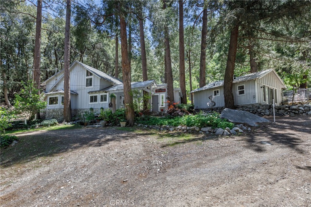 Private Mountain Escape with Expansive Views, Acreage & Guest Studio!
Views, views, views! Welcome to your very own private mountain retreat, where fresh air, natural beauty, and flexible living spaces abound. Set on over one full acre of usable land, this unique property offers breathtaking views and endless potential—whether you're an outdoor enthusiast, hobbyist, or simply seeking tranquility.
The land features a large barn, ideal for a workshop, storage, home office, or creative studio. A spacious flat area offers the perfect space for a corral—a dream come true for equestrians! Several fenced sections provide safe play areas for pets and space to create your ultimate garden paradise.
Inside the main home, you'll find expansive, versatile living areas. The large kitchen flows seamlessly into the dining and lounge space, anchored by a newer wood-burning stove—perfect for cozy evenings or entertaining year-round. A spacious 3/4 bath with laundry and private patio is also located on this level.
Just a few steps up, enjoy the comfort of a large family room with built-in bookshelves, a freestanding woodstove, and a charming reading nook. From here, explore a separate living area with a unique layout: a 3/4 wet bath, loft-style sleeping space, and a stunning “treehouse” bedroom with deck access and panoramic views.
The upper levels include a generous primary suite with full bath and walk-in closet, as well as an additional bedroom with its own 3/4 ensuite—ideal for guests or extended family.
But that's not all—this property also includes a fully self-contained studio guest house on the ground level, complete with its own 3/4 bath, kitchenette, and private dual entrances—perfect for visitors, in-laws, or potential rental income.
All of this is located just:
30 minutes to Redlands
1.5 hours to Los Angeles
2 hours to San Diego
1 hour to the ski slopes
And only minutes from premier Southern California hiking trails
If you're looking for a one-of-a-kind property that offers privacy, versatility, and breathtaking surroundings, look no further. This mountain gem is ready to welcome you home.