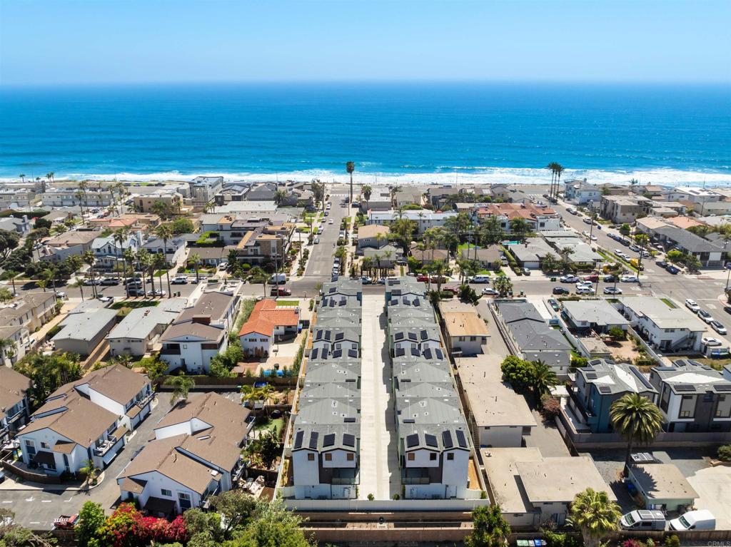 Brand NEW Coastal Townhome Just Steps from the Beach! *Builder is offering a generous rate buydown incentive. Special financing options available to qualified buyers.* Welcome to 3584 Garfield St, an exquisite 3-story townhome nestled in one of Carlsbad's most sought-after beach neighborhoods, just one block to the ocean. Offering 2,054 sq. ft. of luxurious living space, this new Twelve West home features 3 spacious bedrooms, a bonus room/office on the first floor, and 2.5 bathrooms. Enjoy seamless indoor-outdoor living with a deck off the great room and a private, fenced south-facing backyard. Designed with modern coastal living in mind, this stunning home includes European oak wood floors throughout (no carpet), ample storage, owned solar panels, smart home technology, and a direct-access 2-car garage. The gourmet kitchen is equipped with high-end Wolf and SubZero appliances, including a 36" dual fuel 6-burner gas range, microwave drawer, SubZero refrigerator and separate wine fridge, quartz countertops, a large island, and soft close, white shaker cabinetry. The walk-in pantry, wine bar with floating shelves, designer tile, premium Kohler plumbing fixtures, and elegant lighting complete the space. The primary suite features vaulted ceilings, a large walk-in closet, and a spa-like bathroom with a luxurious shower and high-end finishes. Twelve West is nestled just a block from the beach and a quick stroll into downtown Carlsbad Village, offering easy access to beaches, shops, restaurants, parks, and trails. This new coastal community perfectly blends contemporary design with the relaxed lifestyle of the Pacific Ocean. Each of these light-filled homes showcases breezy decks, private yards, and spacious layouts—up to 2,258 sq. ft. of refined living space. Explore fresh interiors expertly curated by our award-winning design team, including timeless finishes, create a truly exceptional living experience at Twelve West. Live the ultimate coastal lifestyle in one of Carlsbad’s most desirable locations.