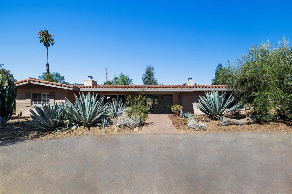 This property offers 2,100 sq. ft. of flex/creative space, along with a Weir Brothers home, and is available on one of the most coveted streets in Pauma Valley. Enjoy the cul-de-sac of South Mesa Drive, with ocean breezes in the evening, and amazing views of Palomar Mountain. This property is surrounded by groves and nurseries...a peaceful and quiet retreat for creative souls. The beautifully restored main ranch house (almost 2,000 sq. ft.) features wood beam ceilings, handmade cabinetry, and master craftsmanship throughout. Close to town, the property includes a barn and 1½" water main with water rights for 5 acres. California Native plantings continue throughout the low water/maintenance landscape. Included is a family orchard with peach, plum, apricot, macadamia nut trees, and numerous citrus trees. Roads throughout the property, with numerous circular driveways. The metal building/studio/creative space has a separate electrical meter & septic. Less than 2 hrs. to Los Angeles. Priced to sell.