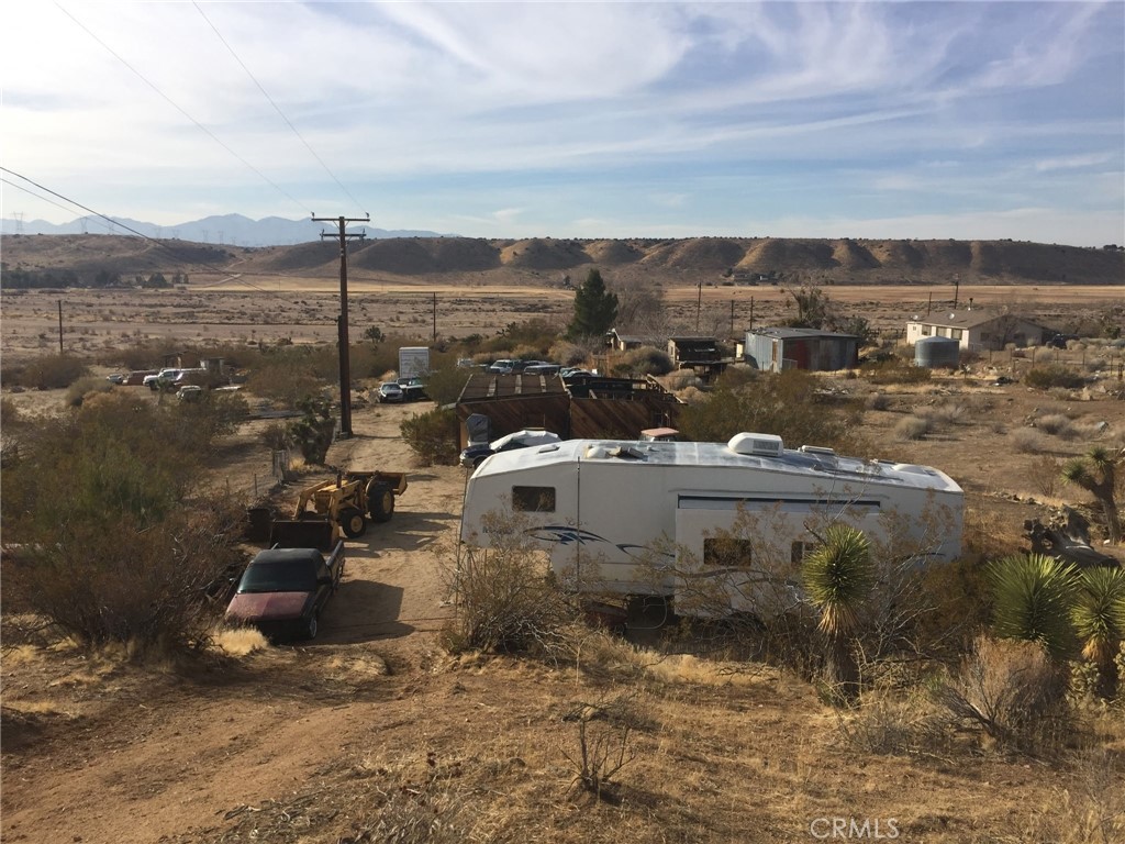 Calling LAND INVESTORS! This seller is willing to accept a DOWN PAYMENT AND CARRY BACK A MONTHLY PAYMENT until paid in full! NO QUALIFYING!! ENDLESS VIEWS, ENDLESS POTENTIAL! Nestled on 3 BREATHTAKING ACRES in the heart of the desert, this unique property with UNOBSTRUCTED VIEWS OF THE DESERT, MOUNTAINS, AND EVEN THE RIVER--WHEN IT FLOWS! Watch the SUNRISE AND SUNSET PAINT THE SKY from your future dream home. A PARTIALLY BUILT, PERMITTED 945 SQ. FT. 2-BEDROOM, 1-BATH STRUCTURE sits on the land--previously affected by fire, it's now a BLANK CANVAS ready to be completed to your vision. GOLDEN OPPORTUNITY for builder, investor, or visionary buyer looking to escape to the serenity of rural living. ***VIEW VIEW VIEW!!!*** Also included is a 33 ft. 2003 Maaco Gulf Stream 5th Wheel RV, offering immediate use or comfortable living while you build. A 945 sq. ft. foundation with plumbing for kitchen and bathroom with some walls. BUYER TO VERIFY ALL PERMITS, UTILITIES, AND ZONING.