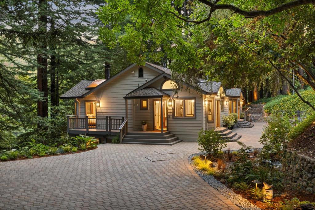 Welcome to Quail Hollow, a rare, custom-built retreat on 2.5 serene acres in the Los Gatos Mountains with stunning landscaping. With over 4,000 square feet of thoughtfully designed living space, this private sanctuary offers a harmonious blend of natural beauty, architectural character and modern luxury. Built in 1993, the main residence features soaring ceilings, rich wood finishes and expansive windows that bring the forest indoors. The two-level layout includes multiple living areas, a dramatic great room, custom-ceiling bedroom, lower-level gallery, and bonus rooms ideal for multi-generational living, studios, or remote work. A charming 1-bed/1-bath cottage with private patio (ADU) is currently generating passive income. Over $700K in upgrades include a reimagined chefs kitchen with a suite of Thermador appliances, dual 5000-gallon water tanks, advanced water softener, upgraded pump, new drainage system, and a paved private road. Enjoy reliable fiber-optic internet, an outdoor fireplace, dedicated sheds, and sweeping views beneath majestic redwoods. Whether you're seeking a personal haven, an artist's enclave, or a home that effortlessly adapts to your evolving lifestyle, Quail Hollow offers unmatched privacy, versatility, and inspirationjust minutes from downtown Los Gatos.