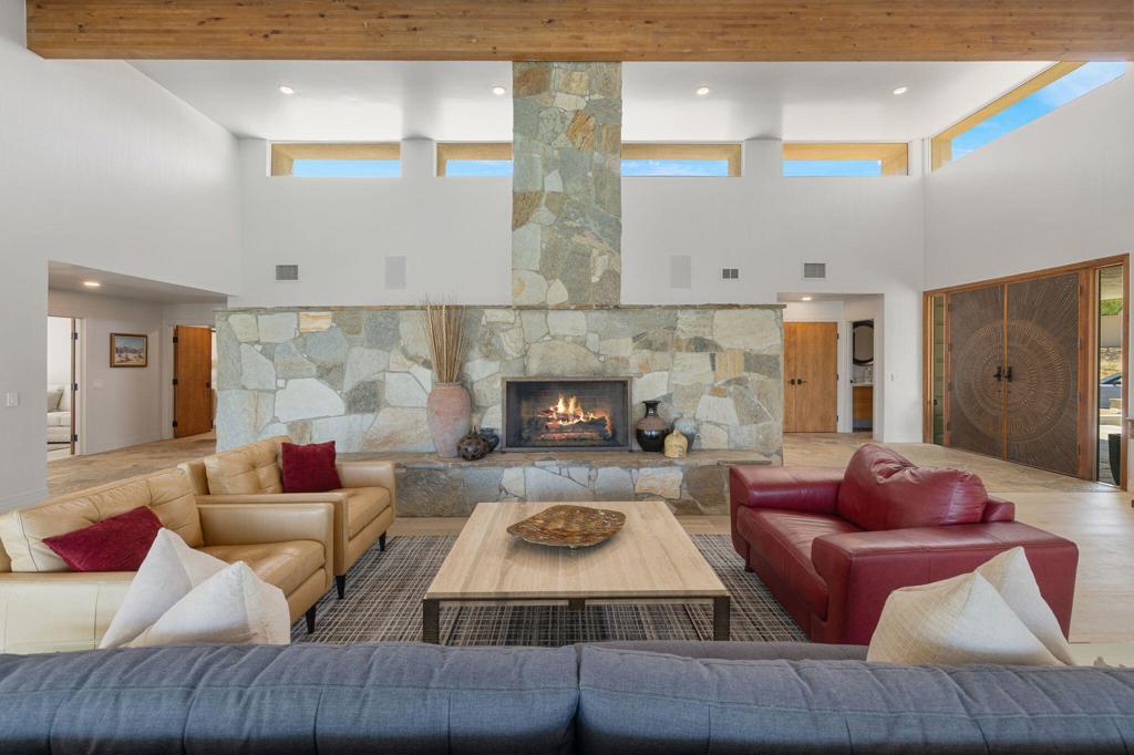 Custom Estate Home on 1/2 acre in the heart of Ironwood Country Club. Private setting with mountain views and serene gated grounds. Enjoy the outdoor amenities of pool & spa, waterfall wall, putting green, built-in BBQ, misters and lush landscaping. Fabulous Great Room features include Quartz stone fireplace wall, high ceilings with clerestory windows and bar area with floor-to-ceiling wine cabinet, icemaker & fridge. Enjoy cooking & entertaining in the spacious custom kitchen featuring SubZero fridge, Wolf 6-burner range, white oak cabinetry and Quartz counters. Large laundry room is adjacent to the kitchen. Doors & windows are updated and flooring is white oak engineered wood and slate stone entry hall.4 bedrooms 4+ baths with 3-ensuite bedrooms and detached casita with bath. The Primary suite has fireplace and luxurious bath with his & hers vanities & 2- cedar lined walk-in closets. Guest suite also has fireplace and there is a 3rd bedroom off the kitchen area. The bedrooms are nicely separated and each has a patio area. Multiple patios with different sun orientation allow outdoor enjoyment any time of the day. In addition to a separate entry casita there is an office plus a media room/den. The attached 3-car garage has custom flooring. This home comes equipped with a fully-owned solar panel system meaning lower electric bills and energy independence. Simply put 'this home has it all' and is offered furnished per inventory,