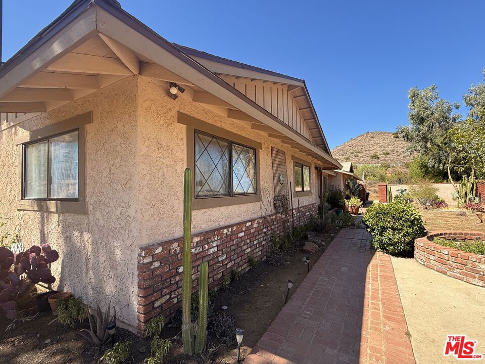 Charming Single Story Country Retreat with Barn, Horse Facilities & Expansive ViewsNestled on 2.5 picturesque acres, this 4-bedroom, 2-bath, 1,700 sq ft home combines privacy, open space, and endless potential. Enjoy panoramic mountain views from nearly every angle, plus a separate barn, horse facilities, and ample room for multiple vehicles, RV parking, and more. Located on a private road near miles of riding and hiking trailsand just minutes from iconic Vasquez Rocksit's a dream setting for equestrian lovers, outdoor enthusiasts, or anyone seeking a peaceful rural lifestyle within easy reach of Los Angeles and the San Fernando Valley, the spacious country-style kitchen with stainless steel appliances flows into a sunny dining area. A separate living room with a large brick fireplace provides a cozy gathering spot, while the family room features a custom wood bar, potbelly stove, and tile flooring perfect for entertaining. The primary master suite opens to a large covered patio, ideal for relaxing with your morning coffee. With its incredible setting, functional layout, and opportunity to update to your style, this property is a rare find for those seeking both space and potential. Information deemed reliable but not guaranteed. Buyer to verify all information.