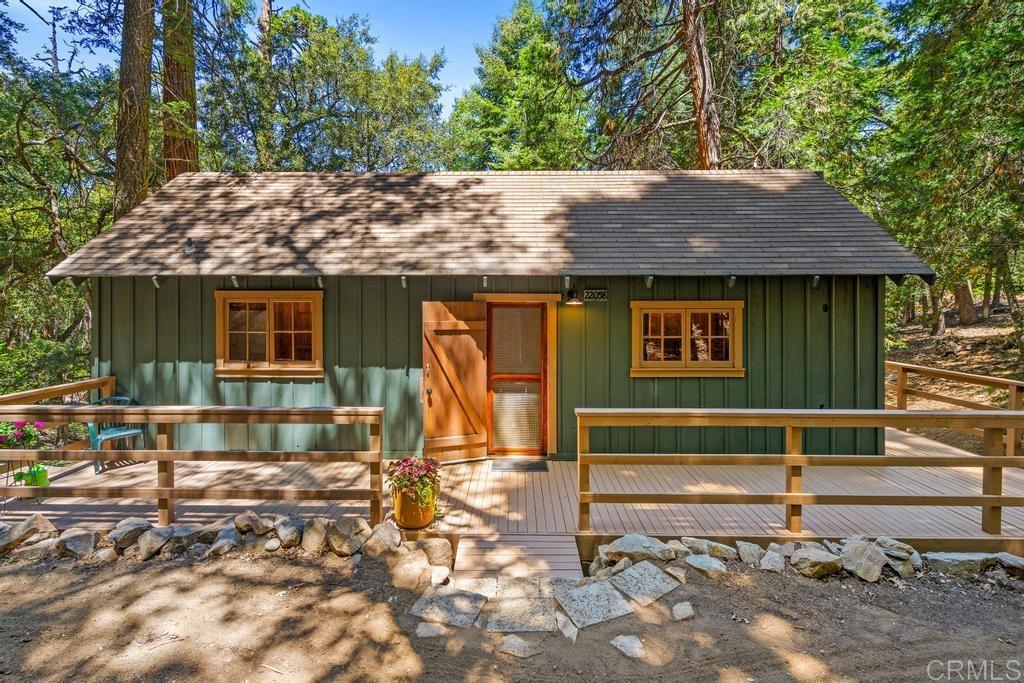 Tucked away on a lush, private 0.33-acre parcel beneath a canopy of majestic Douglas firs, fragrant cedars, and stately oak trees, this enchanting 1932 cabin is a rare gem at an affordable price. Thoughtfully updated while honoring its rustic roots, the home welcomes you with warm filtered sunlight and an unmistakable sense of peace. ~Inside, the cabin features one cozy bedroom, a full bath, two charming sleeping lofts, and a generous basement space for added flexibility. A solid stem wall foundation provides lasting structural integrity, while recent improvements ensure a truly turnkey experience. Upgrades include new appliances, stylish flooring, a refreshed bathroom, fresh exterior paint, a new wall heater, water heater, and additional improvements aimed at long-term comfort and ease of ownership. ~The expansive wrap-around deck invites you to relax among the trees, dine outdoors, or simply take in the tranquil mountain air. ~ Located in the serene community of Palomar Mountain, this property offers easy access to hiking trails, scenic lookouts, and the iconic Palomar Observatory. Whether you're seeking a cozy weekend escape, a year-round retreat, or a charming vacation rental, this cabin delivers the quintessential mountain lifestyle.