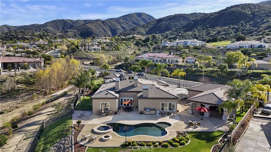 This stunning single-level 4,058 sq. ft. Amberhill estate in the highly sought-after Pinnacle community offers an unparalleled blend of luxury, space, and functionality. Featuring four generously sized bedrooms and four bathrooms, this home is designed for both comfort and entertainment. Outdoor living are,  a 12-car garage provides ample room for car enthusiasts, extra storage, or a workshop space, with epoxy-coated floors and ample cabinetry throughout. The garage setup includes a 4-car attached garage, a 6-car detached garage, and an additional 2-car detached garage.



Inside, new luxury vinyl plank flooring and plantation shutters enhance the home’s modern and elegant aesthetic. The family room boasts a custom-built entertainment center, seamlessly connecting to the open-concept kitchen. A chef’s dream, the kitchen features granite countertops, a 48” built-in refrigerator, dual ovens, a walk-in pantry, and a full bar area—ideal for hosting gatherings.



Step outside into your private backyard oasis with breathtaking views. Designed for entertaining, the 1,250 sq. ft. outdoor living area includes surround sound, a built-in BBQ, two fire pits, an outdoor refrigerator, and an ice machine. The resort-style pool and spa, easily managed by the AquaLink system, create the perfect retreat. The beautifully landscaped yard features custom pavers, stamped concrete, extensive outdoor lighting, and 24 mature fruit-bearing trees. Additionally, a wrought iron dog run is conveniently located on the side yard. 



For added security and peace of mind, the home is fully gated and equipped with an 18-camera security system recording 24/7, along with a 12-camera Ring system. Freshly updated with new interior and exterior paint, the property also features new 5-ton and 3.5-ton AC units for year-round comfort.



This extraordinary estate seamlessly blends modern amenities, elegant design, and breathtaking outdoor spaces in one of the most coveted communities. Don’t miss this rare opportunity—schedule your private showing today!