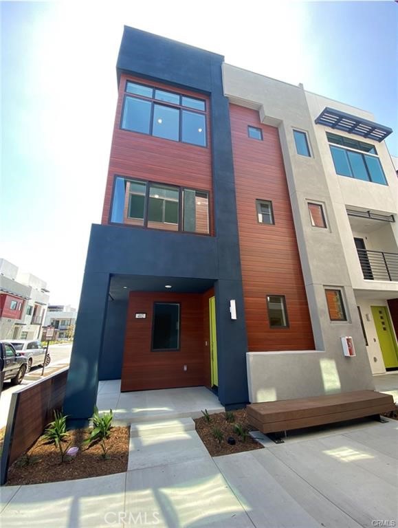 Desirable Urban Contemporary three-story townhome with 4 bedrooms, 3.5 bathrooms located at Tustin Legacy. First floor features a secondary bedroom with full bath, attached two-car garage and cabinets for storage. Second floor enters into the spacious living area featuring a great room, glass sliding doors leading to the covered deck, and dining room. The gourmet kitchen includes a center island, quartz countertops, appliances, walk-in pantry, and a powder room conveniently located. Third floor leads to the large owner's suite with high ceiling bedroom featuring a walk-in closet and bathroom with walk-in shower and dual vanities. There are also two secondary bedrooms, a full bath with dual vanities and a laundry room. Refrigerator, washer and dryer. This Wi-Fi Certified Home package includes smart home products from the most trusted manufactures – including Amazon, Ring, Honeywell, Schlage, and Ruckus – to provide a better home networking experience. Attached two-car garage with an EV charger. Enjoy access to the association amenities including a swimming pool, spa, barbecues, showers and restroom. Convenient location - minutes to parks, The District shopping centers, John Wayne Airport, Metrolink, Irvine Business Complex and much more.