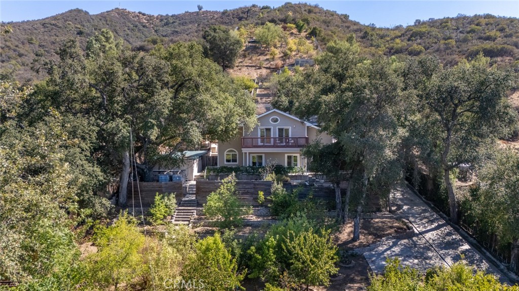 One of a kind! A private orchard carved out of the mountain. As you enter the gates of this 2.2 Acre lot, you approach hundreds of fruit trees that have been meticulously planted. Just behind this beautiful garden sits a 3000 sq ft house built in 2004. With a great floorpan, spacious bedrooms, and amazing views of your garden, this is truly a Sunland Villa. Next to the house is an above ground pool, and behind the house is a 2 car garage with a workshop and a bathroom! An amazing opportunity to build a spacious ADU while keeping costs low. Behind this garage is the true beauty of this villa. A lifelong engineer transformed this mountain side into a multi terraced garden. What would usually be unusable land is now the most amazing garden in the foothills. The property line goes until the very top of the mountain, but the crazy part is that there is water and power all the way to the top! This property is truly a one of a kind and the photos do not do it justice, come see it in person!