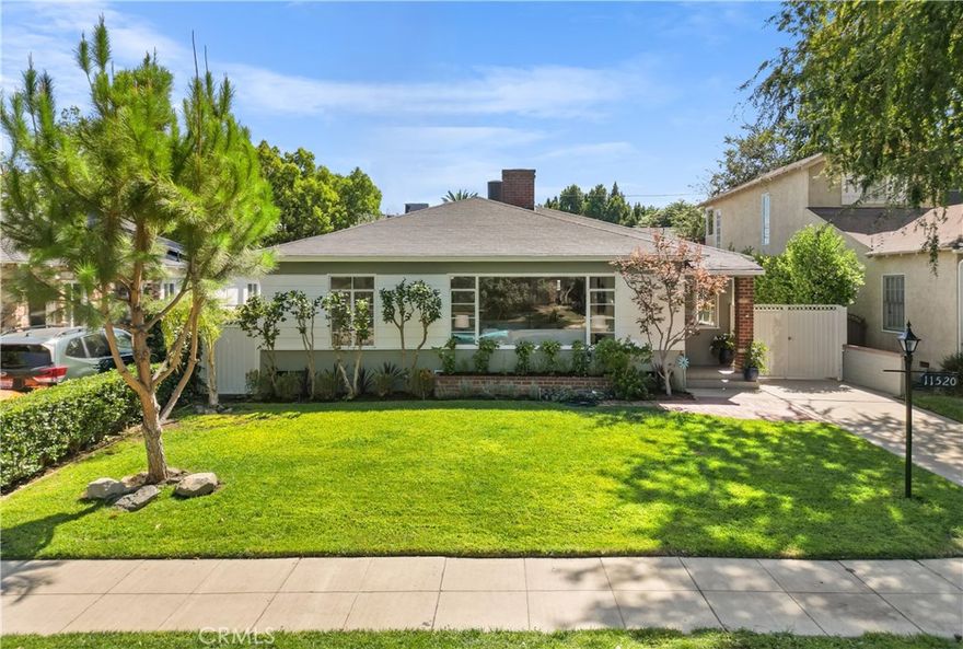 Welcome to this updated Traditional-style home that blends timeless character with thoughtful upgrades, all set in a serene landscaped setting. Relax in the front yard while enjoying the birds, or take in the seasonal views through the expansive picture window in the living room. A cozy fireplace, built-in bookcases, and charming nooks add warmth and elegance. Original hardwood floors, abundant closet space, and central air and heat provide both comfort and functionality.

The spacious kitchen features Saltillo tile floors, concrete countertops, stainless steel appliances including a 36" gas range with hood, and a full-size refrigerator. A sunny dining area with abundant windows creates a bright, cheerful space to gather.

Offering 2 roomy bedrooms and 1 ¾ baths, the home is enhanced with tile floors, updated lighting, and stylish hardware. The backyard includes a finished garage, ideal as a workshop, office, or future ADU. A covered rear porch provides the perfect setting for al fresco dining and entertaining.

Just moments from the vibrant NoHo Arts District, this home offers both charm and convenience in one inviting package.