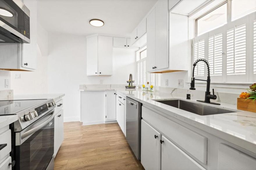 Experience comfortable, low-maintenance living in the heart of San Leandro. This updated 2-bed, 2-bath condo offers an open layout with floor-to-ceiling windows that fill the space with natural light and showcase neighborhood views. The kitchen features new stainless steel appliances, quartz countertops, refreshed cabinets, a new sink and faucet, and farmhouse shutters. Additional upgrades include new laminate flooring, baseboards, lighting, hardware, fresh paint, and new bathroom vanities. A secure, gated building provides an assigned garage parking space, elevator access, and community laundry. Located one block from Safeway, shops, restaurants, and the San Leandro Farmers Market, plus just a few blocks from BART with easy freeway access. A great opportunity for first-time buyers, downsizers, or investors. Welcome home!