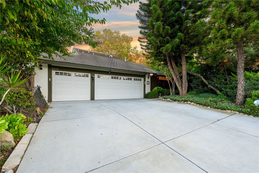 Welcome to this inviting Canyon Crest home — where comfort, privacy, and outdoor beauty come together. This spacious 2-story home offers 5 bedrooms, 3 full baths, and a 3-car garage, giving you plenty of room for family and guests. Step inside to cathedral ceilings and a light, airy feel. The living room and family room both boast a fireplace, perfect for cooler evenings, while ceiling fans throughout keep the home comfortable all year. The kitchen is bright and welcoming with classic tile counters and generous cabinet space - great for casual meals or entertaining friends. Upstairs, the primary suite is a peaceful retreat with a large walk-in closet, a roomy bath, and access to an upstairs balcony where you can enjoy beautiful views and evening breezes. Outside, the backyard feels like your own private escape. Lush landscaping, mature trees, and fruit trees surround a sparkling swimming pool and outdoor fireplace — a perfect spot to relax or host gatherings. The greenery and thoughtful design create a true sense of privacy and serenity rarely found in the city. With its functional layout, resort-style outdoor space, and picturesque views, this Canyon Crest home offers a wonderful blend of comfort, charm, and everyday enjoyment.