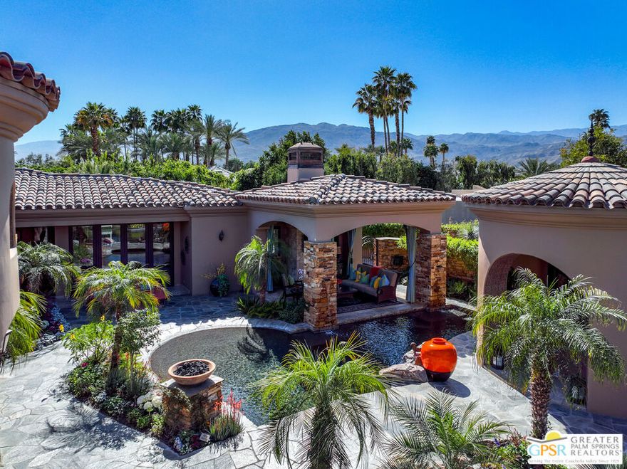 Welcome to 3 Coronado, a custom-built Mediterranean estate offering the perfect balance of elegance, space, versatility, and luxe amenities. Conveniently located in the exclusive enclave of Coronado Rancho Mirage, just one mile from Eisenhower Medical Center, restaurants, and shopping, this completely walled and gated compound embraces upscale desert living at its finest. Situated on one fully landscaped acre, 3 Coronado serves up 7,600 square feet of living space with a total 4 bedrooms, 5.5 baths, and 8-car garage parking between the main and guest houses. Throughout, you'll appreciate the elevated craftsmanship and upgrades, including travertine tile, cedar-lined closets in all en-suites, solid core doors, wood shutters, Hunter Douglas remote shades, integrated speaker system, and an abundant use of marble and granite. Enter the property through the first rotunda to find an awe-inspiring serene oasis where water features, mature vegetation, and pristine architecture captivate the senses. In the distance, a breathtaking second rotunda transports visitors into the elegant main home which is designed for entertaining and relaxed family gatherings. Proceed to find a massive great room complete with dramatic coffered ceiling, gallery walls, and the first of four fireplaces. The dedicated bar area includes sink, refrigerator, wine cooler, dishwasher, and Sub-Zero ice maker. The formal dining room connects conveniently to the butler's pantry with sink, dishwasher, microwave, and easy access to the wine cellar. The jaw-dropping chef's kitchen features Wolf and Sub-Zero appliances and stunning walk-in pantry. Beyond the kitchen's breakfast bar, find a comfortable living room, dining area, laundry, and two beautiful en-suite bedrooms. The spectacular primary bedroom suite is located on the opposite side of the home offering wonderful separation and privacy. It showcases a double-sided fireplace, dramatic granite shower, wet bar, and dual sets of vanities, water closets, and walk-in closets. The main house's 6-car garage offers ample built-in storage and a workstation. The detached one-bedroom guest house has a 2-car garage. Friends and family will enjoy its covered patio, bar area, and en-suite with dual vanities, walk-in shower, and tub. The entire estate is purpose-built for effortless indoor-outdoor living. Fully retractable walls of glass in the great room, two sets of folding panel doors in the formal dining room, and French doors in the primary and guest suites all provide seamless access to a west-facing outdoor desert wonderland. Here you'll discover an oversized lagoon-like walk-in Pebble Tec pool, 24-person spa, second smaller spa, outdoor living room with fireplace, covered dining areas, and outdoor kitchen. In the back of the home, east-facing French doors in the office open to reveal a tranquil patio area, fruit trees, three fountains and pathway. The mixed use of travertine tile, stacked stone, and flagstone outdoors is striking. Other features include: 42-owned solar panels, 6 overhead outdoor patio heaters, newer HVAC and tankless water systems, newer security gate engines, new driveway drainage, freshly painted. HOA of $650/month includes common area landscaping and community gate. You can have it all, including most of the furnishings so bring your toothbrush!