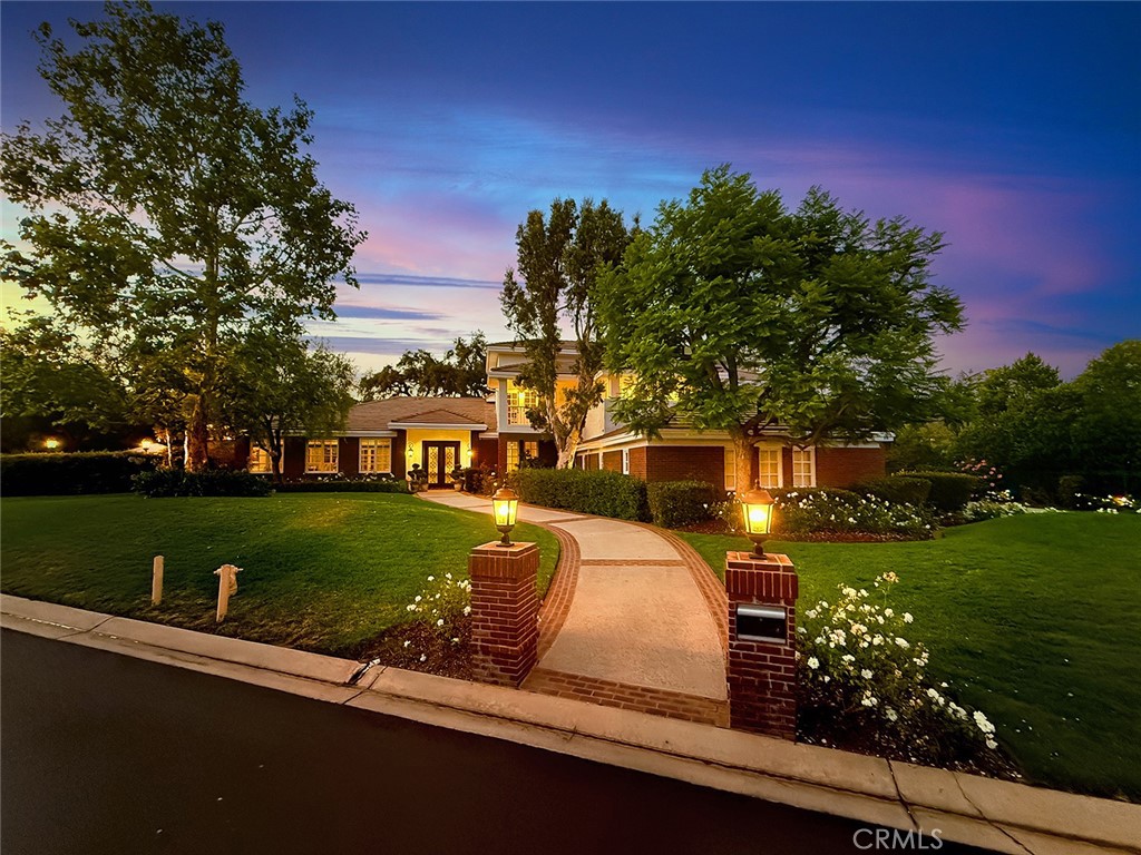 Welcome to 5135 Island Forest Place — a private sanctuary gracefully positioned along the serene sixth fairway of the esteemed North Ranch Country Club. This contemporary estate is a testament to architectural elegance and thoughtful design, encompassing over 5,100 square feet of living space. With five generously appointed bedrooms and five bathrooms, the home offers abundant room for both grand entertaining and quiet retreat. Two main-level bedrooms feature ensuite baths, affording exceptional privacy and comfort for family members or discerning guests. Set on over 260 feet of prime golf course frontage, the residence enjoys uninterrupted views of rolling fairways framed by mature oaks providing both visual splendor and a natural sense of seclusion. The expansive great room, crowned by soaring 16-foot ceilings, floods with natural light and offers an ideal setting for sophisticated gatherings, fireside reading, or peaceful reflection. Step outside to a resort-inspired backyard, where a shimmering pool and spa are embraced by lush landscaping, creating an intimate outdoor haven. Whether entertaining under the stars or savoring a quiet morning by the water, this space is designed to restore and inspire. Located on a tranquil cul-de-sac within the exclusive gated enclave of Island Forest—comprised of just 14 distinguished residences—this home offers the rare combination of security, privacy, and community. Low HOA dues add to the appeal of this elite setting. Enhancing the property’s value and lifestyle offering, a significant renovation of the North Ranch Country Club’s renowned golf courses is currently underway, promising an elevated playing experience and world-class amenities upon completion. Unlike other homes in the area, 5135 Island Forest Place is thoughtfully situated away from through-traffic, ensuring a sense of peace that is both rare and cherished, truly evoking the feel of a personal island retreat. Here, luxury meets tranquility in one of North Ranch’s most coveted addresses.