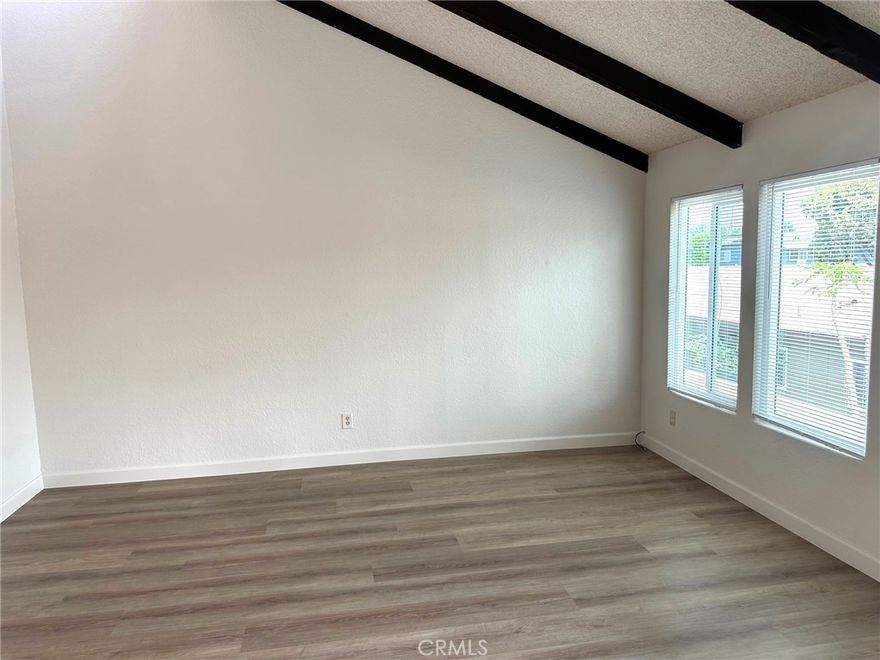 Welcome home to this spacious 2 bedroom, 2 bathroom residence offering approx. 1,100 sq. ft. of comfortable living space. One of our favorite property features is the peaked ceilings with skylights providing abundant natural light. The unit has just been painted and new LVP flooring installed throughout. The kitchen is open to the family room and has a brand new stainless steel gas range. Both bedrooms are generously sized, complemented by two full bathrooms for added convenience. Brand new vinyl windows throughout the unit. Additional amenities include an on-site laundry room, one-car garage, and water service included. Located in the desirable City of Orange, this home combines comfort and convenience. 1-year lease and one month’s deposit required. Qualifying income and credit are a must.