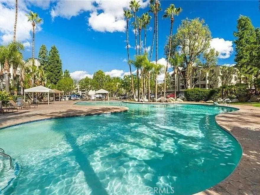 This beautifully upgraded top-floor condo offers comfort, privacy, and resort-style living in the heart of Woodland Hills. The unit features high vaulted ceilings, luxury vinyl plank flooring, fresh paint, and a cozy fireplace. The modern kitchen includes granite countertops and stainless-steel appliances, and the bright living area opens to a private balcony perfect for morning coffee. Enjoy two covered tandem parking spaces and access to The Met's exceptional amenities including 24-hour security, multiple swimming pools, tennis courts, a fully equipped gym, basketball and racquetball courts, and beautifully landscaped grounds. Conveniently located near Whole Foods, Westfield Topanga, The Village, fine dining, and easy freeway access. A perfect blend of style, comfort, and location ready for move-in November