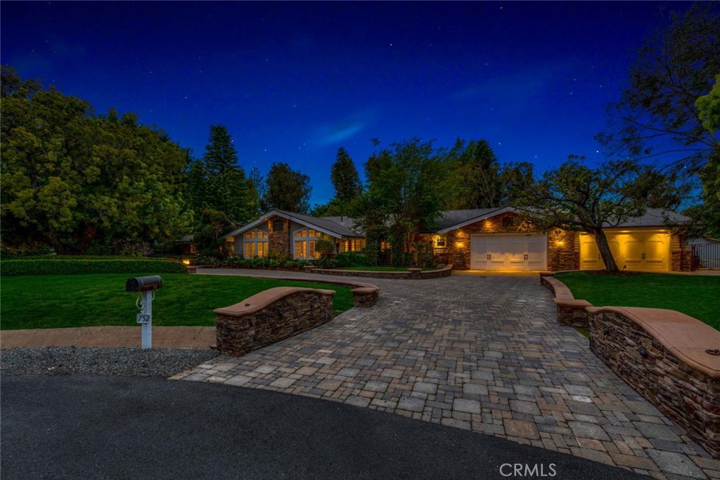 Welcome to 752 N. Creekview Drive, a Custom Estate Nestled on an Acre Cul-De-Sac in Orange Park Acres Lazy Creek Country Estates. Rebuilt in 2011, this Sprawling Ranch Style Home Showcases Six Bedrooms, Six and a Half Bathrooms (Dual Master Suites), Chef’s Kitchen, Two Offices, Music Room, Coffered Ceilings, Custom Woodwork, and Countless Upgrades Throughout. Enjoy Access to the Entertainer’s Dream Backyard from Nearly Every Room in the House, Allowing for the Best of Indoor/Outdoor Living. Upon Entry You are Greeted by Soaring Ceilings and an Open Concept Living and Dining Room Which Feature Vaulted Ceilings, Skylights, a Marble Fireplace, and Beautiful Wall Treatments Throughout. The Gourmet Kitchen Enjoys Marble Counters, Custom Cabinetry, SubZero Fridge, Wolf Stove, Oversized Island with Ample Cabinet Space, Breakfast Nook, and Backyard Views. The Convenient Butler’s Pantry Provides an Additional Sink, Fridge, Oven, and Storage Space. The Kitchen Opens Directly to the Family Room Featuring a Marble Fireplace and Built-In Entertainment Center. The Primary Master Suite Features a Sitting Nook, Dual Vanities with Opal Counters, Heated Floors, Walk-In Closet with Custom Built-Ins, Walk-In Shower, Soaking Tub, and Beautiful Views of the Pool and Garden. The Secondary Master Suite Also Features Dual Vanities, Built-Ins, and a Walk-In Closet. Both Offices Boast Custom Woodwork and Built-Ins Throughout. The Expansive Backyard is Complete with a PebbleTec Salt Water Pool/Spa with Cave, Waterfall, and Slide. Additional Backyard Features Include a Built-In Fireplace, Built-In BBQ, Turf, Garden, Fruit Trees, Lush Landscaping, Fountains, Outdoor Bathroom, Four Stall Barn, and Incredible Underground Castle! Dual Laundry Rooms Conveniently Located Throughout the Home. Direct Access Four Car Garage with Built-Ins, Workshop, Gym Area, and Custom Cabinetry. Direct Access to OPA’s Extensive Horse Trail System Behind the Home. Easy Access to Irvine and Peters Canyon Regional Parks. Minutes from the 5/55/22 Freeways, 241/261 Toll Roads, and Nearby Sought After Schools: Salem, Oakridge, Chapman Hills Elementary, and Orange Lutheran High. No Mello-Roos! 752 N. Creekview Drive is a Must See!