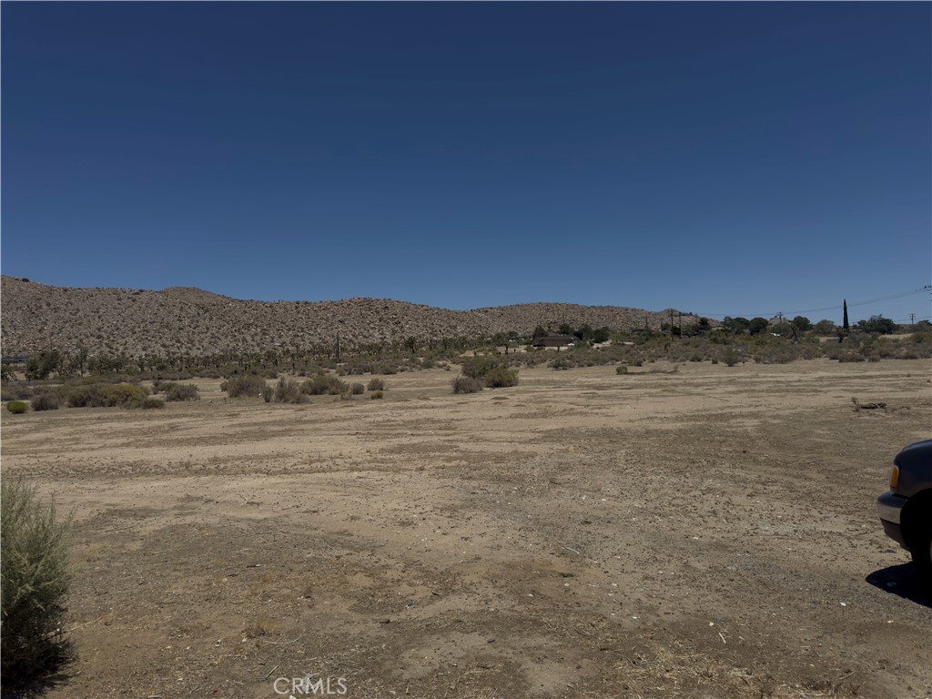 ***EXPANSIVE LOT TUCKED BETWEEN TWO MAJOR PAVED ROADS*** The largest and lowest priced residential lot just a quarter mile north of the Hwy 62 in downtown Yucca Valley. Steps away from Little League park, Yucca Valley BMX Park and the High Desert Nature Museum. Perfect land for a builder or to hold for future use. 29 Palms Highway is the major road that connects Morongo Valley to the towns of Joshua Tree, 29 Palms, Landers and Lucerne Valley. The bustling town of Yucca Valley has designated this area R-L-1, potential for up to six homes in a subdivision. Buyers, Buyers Agents and interested parties should independently check their own usage plans with the local authorities. No guaranties or warranties implied.