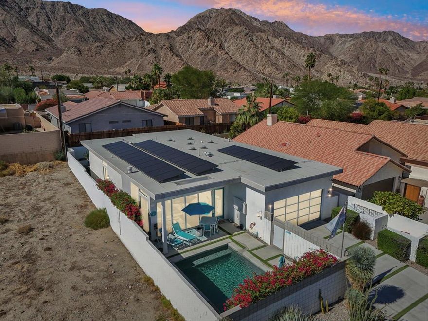 Imagine waking up to breathtaking mountain views every day!Located at the top of the highly sought-after La Quinta Cove, this stunning single-story home offers a perfect blend of modern comfort and desert charm. Featuring 3 bedrooms, 2 bathrooms, and nearly 2,000 square feet of living space, this property is designed for both relaxation and entertaining.The open-concept floor plan is highlighted by sleek tile flooring, soaring ceilings, and walls of windows that fill the home with natural light. A sleek fireplace creates a warm ambiance in the living and dining areas, while the gourmet kitchen impresses with stainless steel appliances, quartz countertops, custom tile backsplash, and an oversized island with seating for six.The primary suite is a private retreat, complete with a mini-split A/C for personalized comfort, a large walk-in closet, and an elegant spa-style bath. Additional upgrades include motorized shades, solar tube skylights, dimmable lighting, and invisible screens throughout.Step outside to your private oasis -- a sparkling saltwater pool, surrounded by gorgeous desert landscaping and panoramic views. It's the perfect place to unwind and enjoy spectacular sunrises and sunsets.Additional features include a spacious laundry room with cabinetry, a two-car attached garage. Hiking trails are just steps away, with shopping and dining nearby.Experience the beauty, privacy, and lifestyle that only the top of the Cove can offer!
