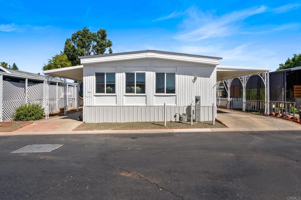 Welcome to the family friendly community of Greenfield mobile estates. This home invites you with a multitude of updates ready for you to move right in and enjoy your home. The home offers three spacious rooms, two remodeled bathrooms, new flooring and dual pane windows throughout the home, updated kitchen, and new appliances. All appliances including washer and dryer will be staying with the property to make your move that much easier. Enjoy one of the largest lots in the community with plenty of space to create an outdoor oasis to entertain. The carport easily fits 2-3 cars, plus plenty of visitor parking for family and friends. There is a community pool and clubhouse for the larger family gatherings or summer fun. Ideal location with Magnolia park, and Magnolia Elementary School being right next door, and easy access to the 67 freeway.