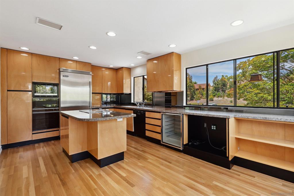 This sophisticated end-unit townhome offers a rare combination of style, quality, and thoughtful design — now priced at just $650 per square foot, well below the ~$700 neighborhood baseline and without factoring in $200+ per square foot of upgrades like newly refinished white oak hardwood floors, full HVAC with heat and air, custom kitchen with top appliances, granite and marble accents, skylights, and more. The result of a no-expense-spared remodel by owners with a true eye for detail, every space has been elevated with premium finishes that make daily living both comfortable and inspiring. The main level entry welcomes you with natural light through custom small-pane sliding glass doors. The fireplace, once ordinary brick, now commands attention with sleek black marble and a remote-control start. The living room flows seamlessly to a private patio, perfect for entertaining, while an arched doorway leads to the two-car garage with washer and dryer. A mirrored powder room — inspired by a famous New York restaurant — adds character. The dining area includes a built-in bar with granite countertop and sink, ideal for hosting. The oversized kitchen is a showstopper, surrounded by picture windows with views of mature landscaping, tennis courts, and pool. Morning sun pours in, with ample space for a seating area, home office, or reading nook, plus built-in cabinetry for books, a TV, and wine refrigerator. Appliances include an oversized Viking refrigerator, Bosch dishwasher, and Gaggenau ovens and cooktop. Italian handcrafted cabinets, granite counters, and a large center island that doubles as a table make this space a chef’s dream. A custom skylight brightens the upper level. One bedroom serves beautifully as a guest suite or office, with built-in cabinets, marble countertop, and hidden refrigerator. The luxurious bathroom features a marble-clad two-person Jacuzzi tub, a dual-sink marble vanity, and a spacious skylit shower. The primary suite is a private haven with abundant closets, built-in cabinetry, a wall safe, hidden storage, a dressing table with Hollywood lighting, and a show-stopping walk-in closet designed to display and organize any wardrobe. This home represents exceptional value in the area.