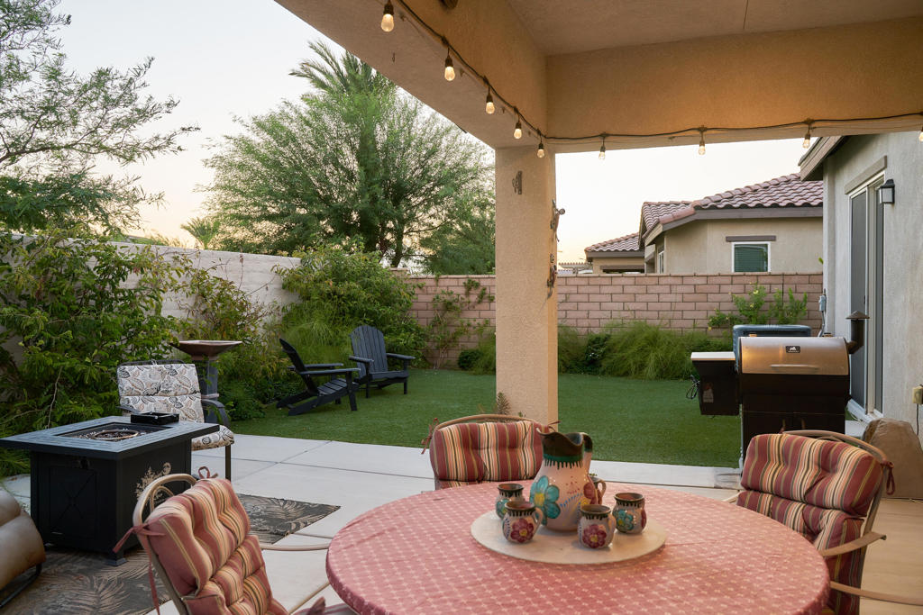 Live the resort lifestyle at Four Seasons Terra Lago! This 3-bedroom, 2-bath home showcases 14-ft ceilings, grey wood-look tile, recessed and cabinet lighting, and a gourmet kitchen with cherrywood cabinets, granite counters, stainless appliances, and island with stainless bar footrest. Relax in a backyard with mountain views, covered awning, outdoor TV, fruit trees, and turf dog run. Garage includes approx. 200 sq. ft. of bonus storage. Low HOA with access to golf, pickleball, pool, clubhouse, and social events. Conveniently located near Fantasy Springs Casino, golf resorts, and I-10 for easy travel.